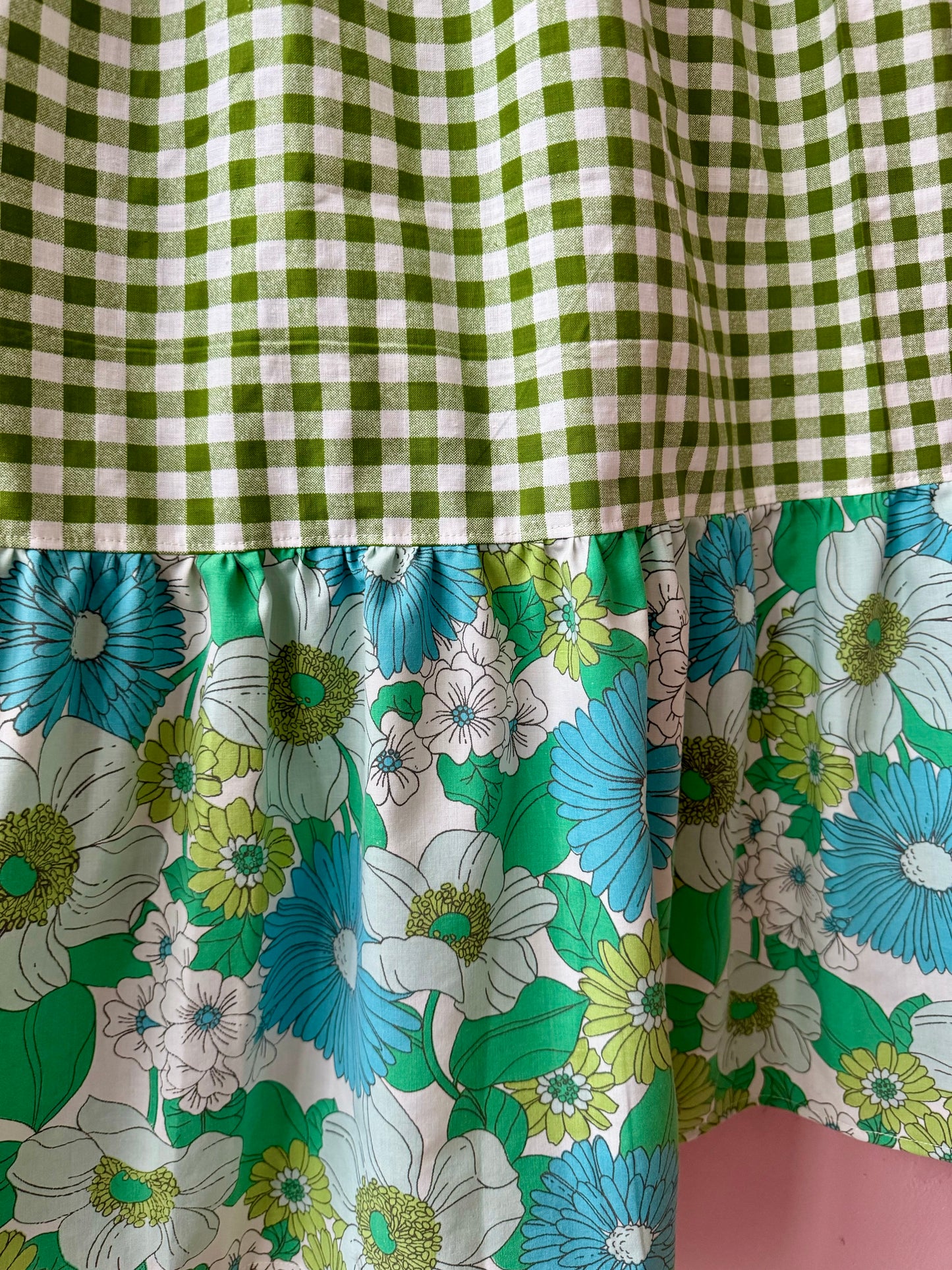 Wrap around dress with green gingham and embroidery