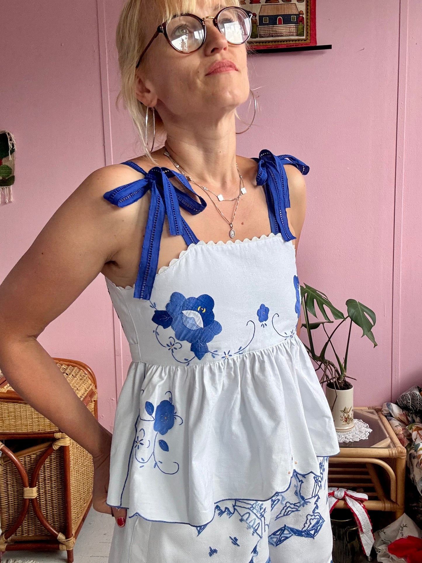 White top with blue floral appliqués