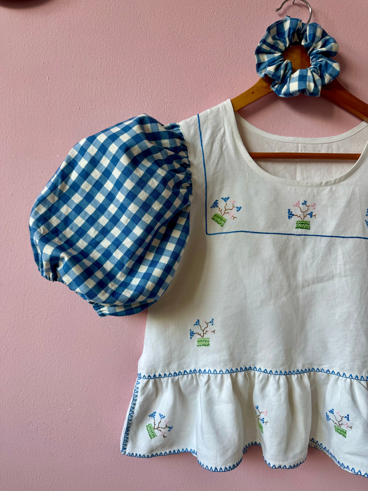 Peplum blouse with hand embroidery and gingham sleeves