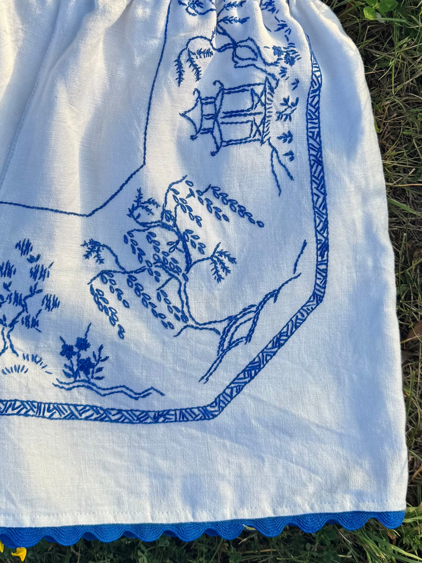 White shorts with blue hand embroidery