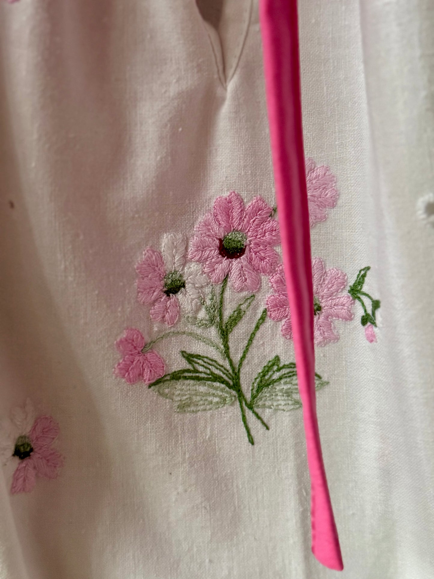 White blouse with pink binding