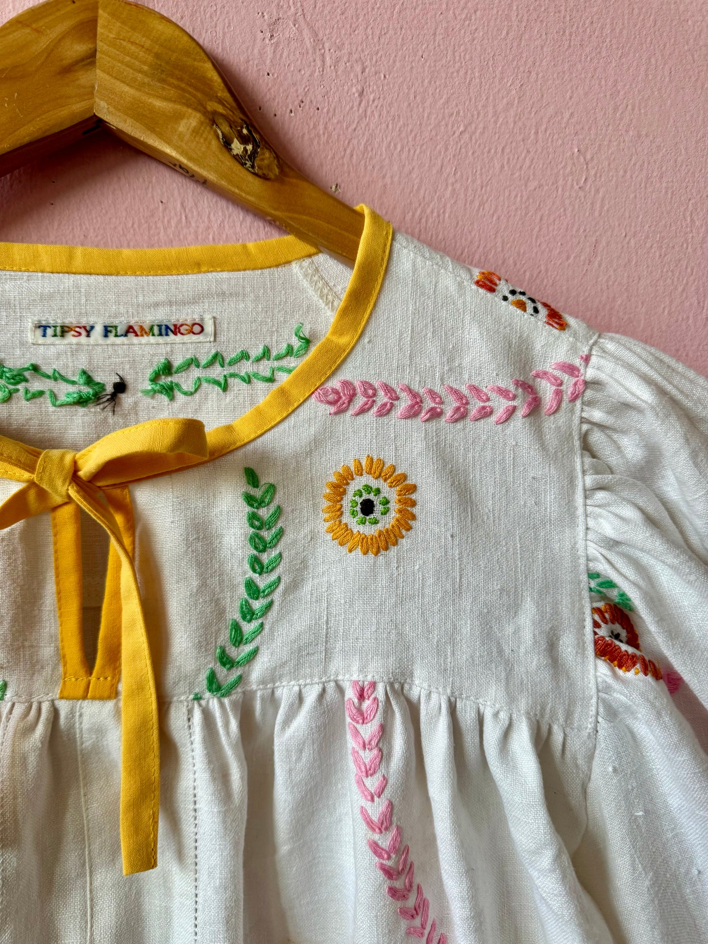 Linen blouse with floral embroidery and yellow binding