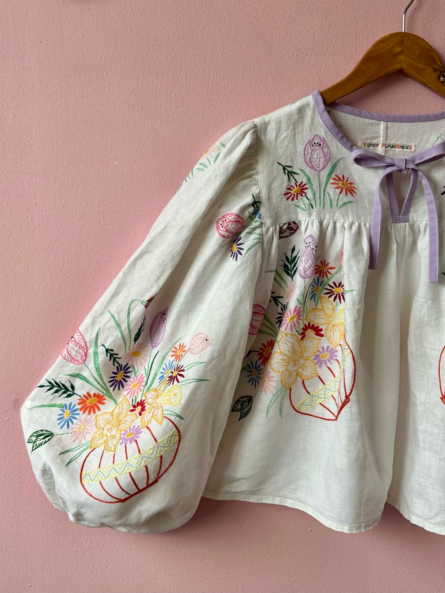 White linen blouse with baskets embroidery and lilac binding