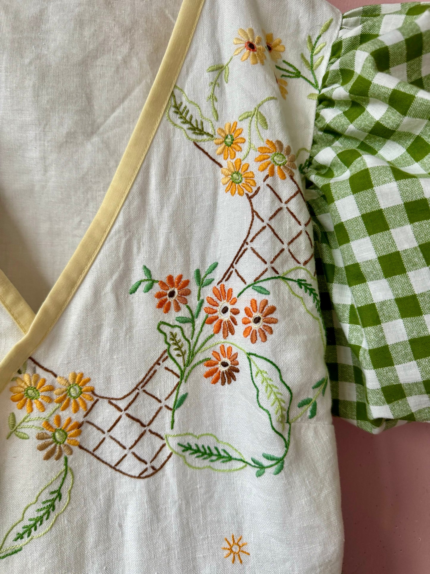Wrap around dress with green gingham and embroidery