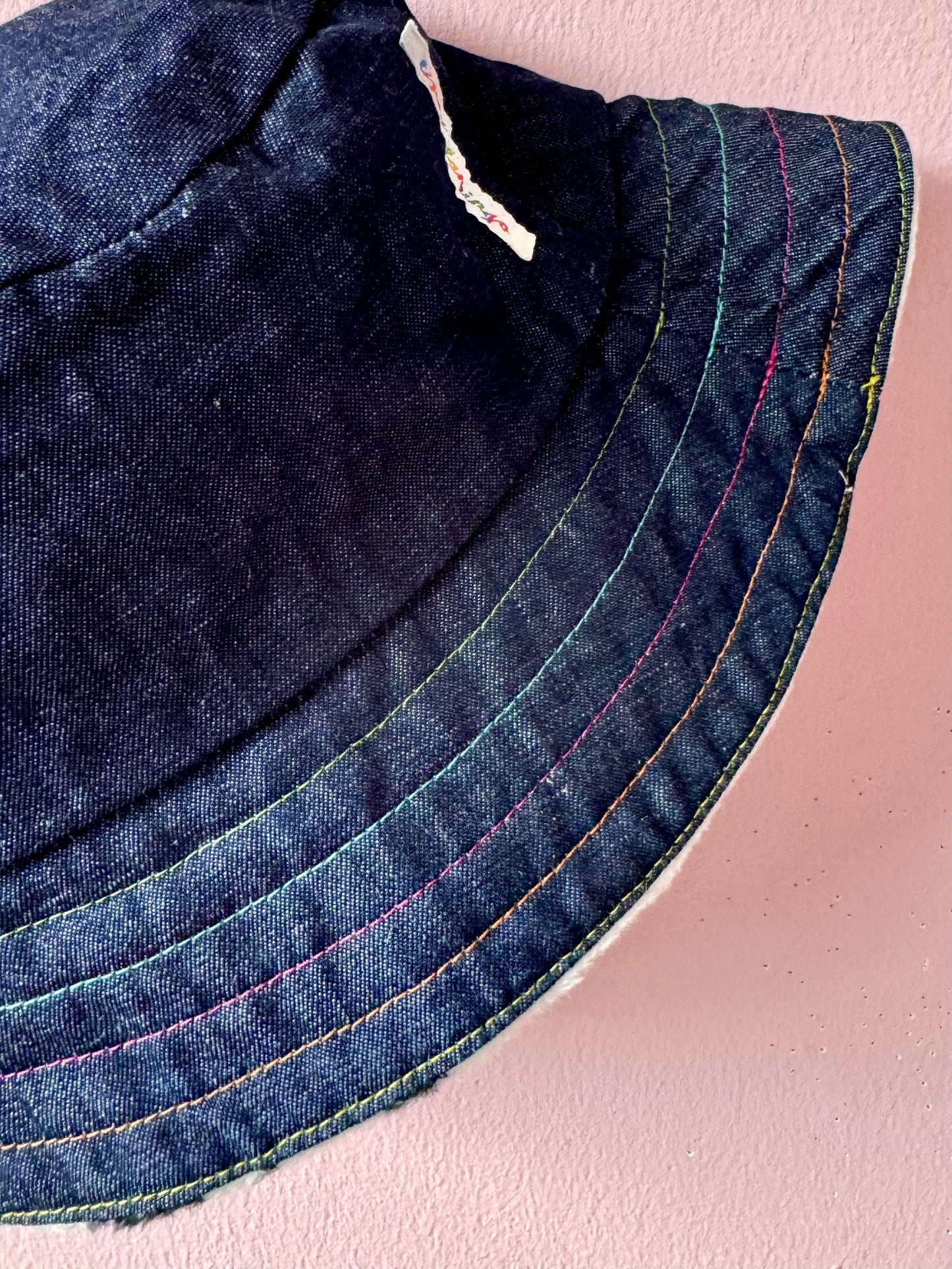 Reversible faux cow fur and denim with rainbow stitching bucket hat