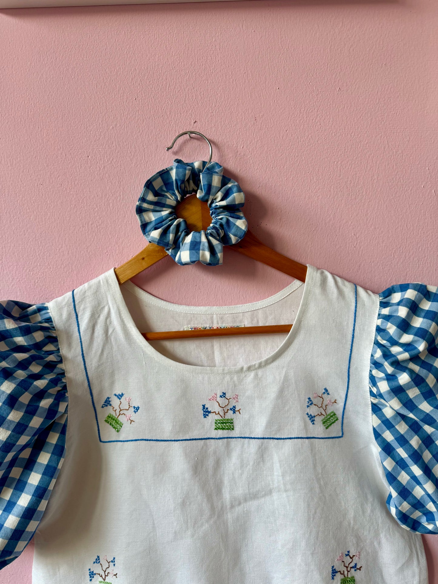 Peplum blouse with hand embroidery and gingham sleeves