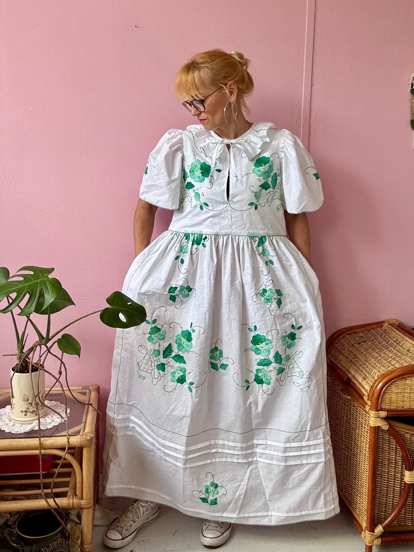 White maxi dress with green floral appliqués