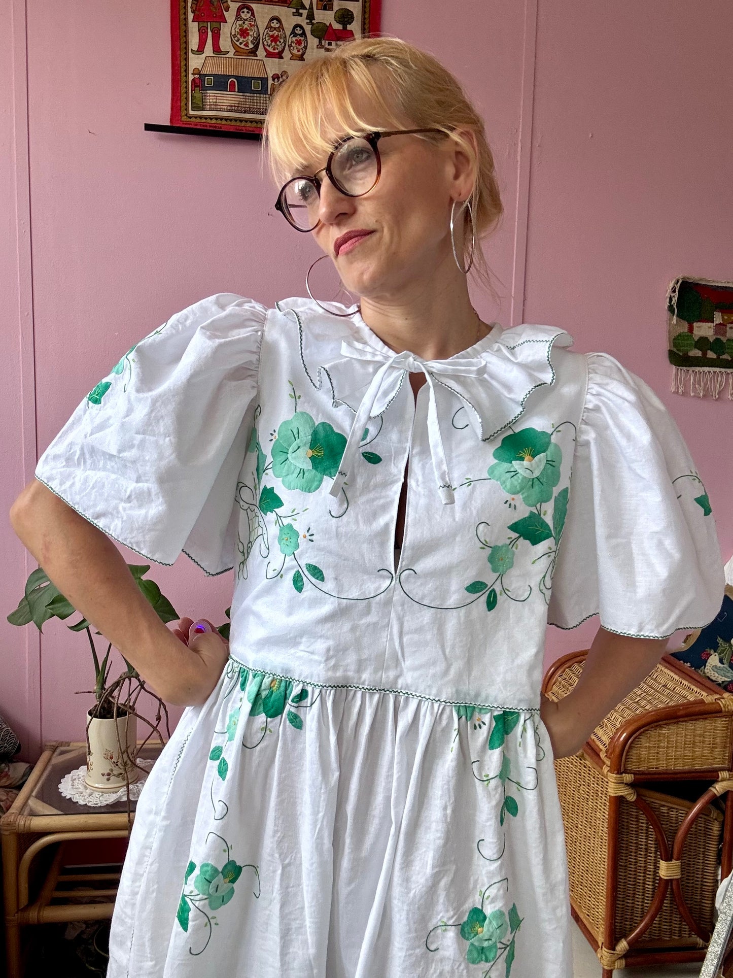 White maxi dress with green floral appliqués