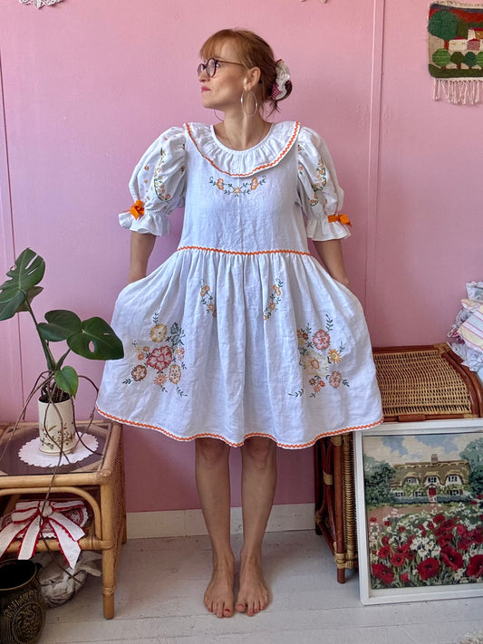 Linen dress with floral hand embroidery and ric rac