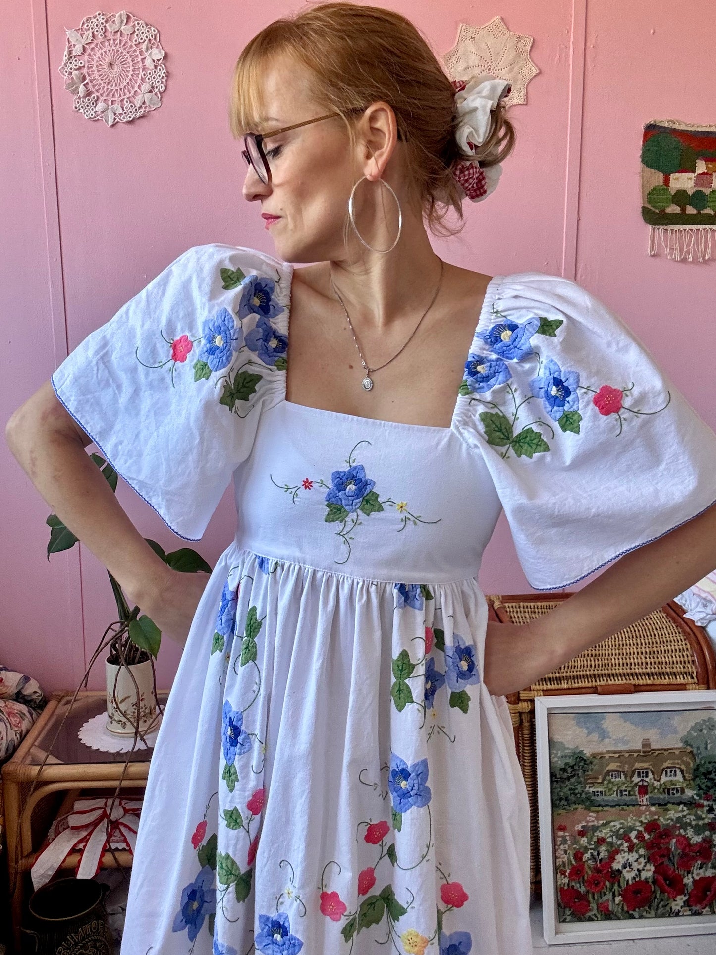 White maxi dress with blue floral appliqués