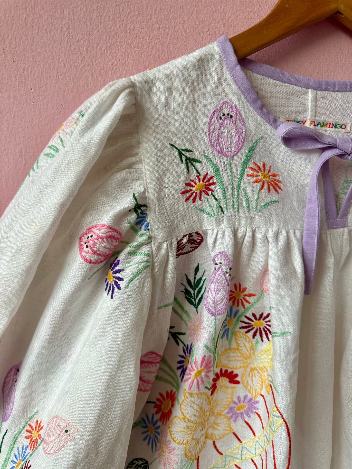 White linen blouse with baskets embroidery and lilac binding