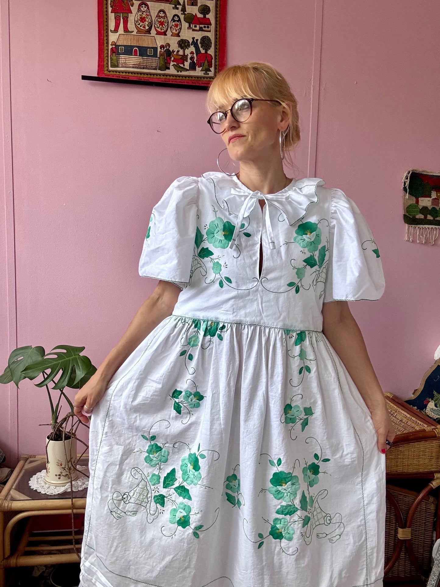 White maxi dress with green floral appliqués