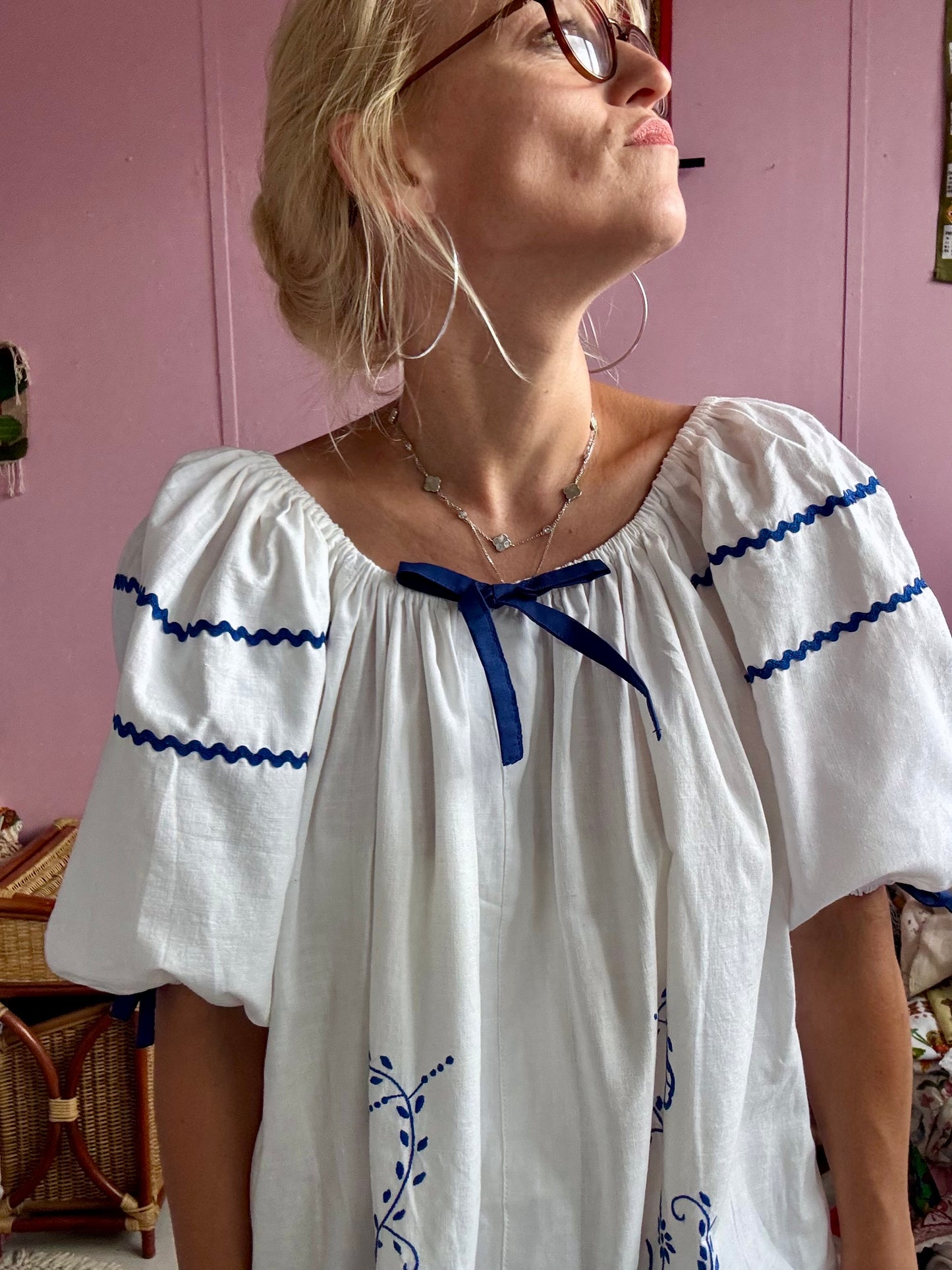 White mini dress with blue embroidery and blue bows
