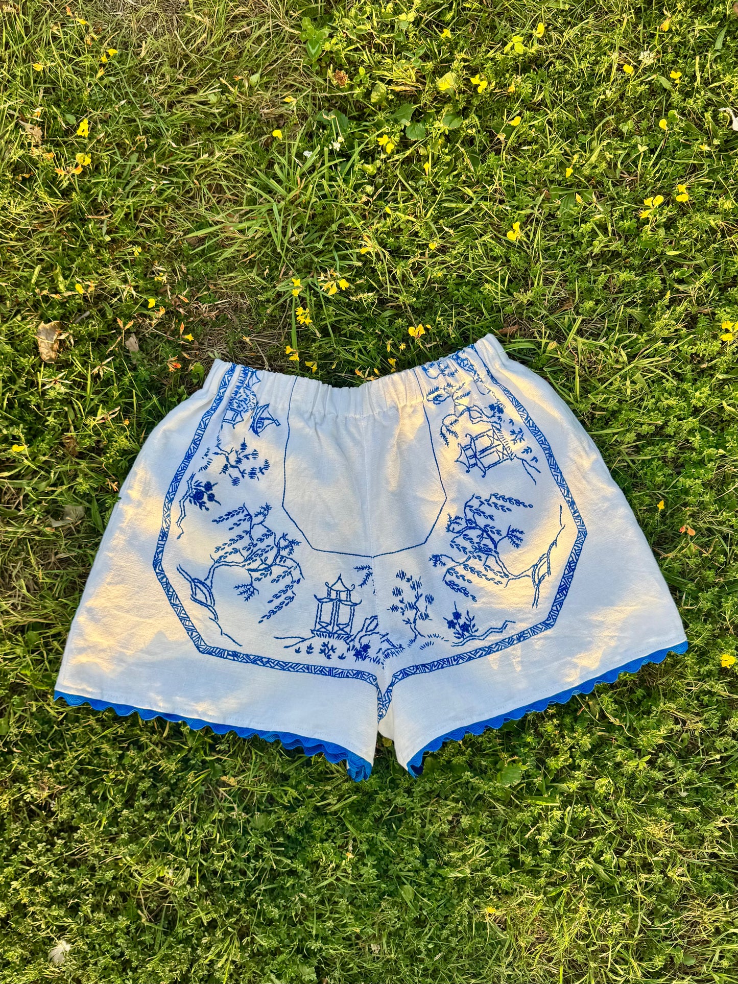 White shorts with blue hand embroidery