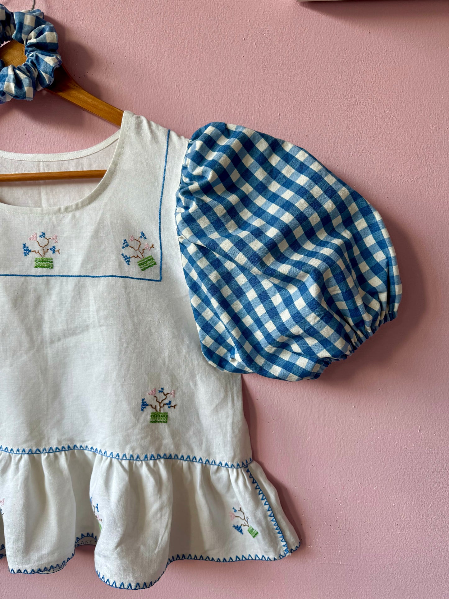 Peplum blouse with hand embroidery and gingham sleeves