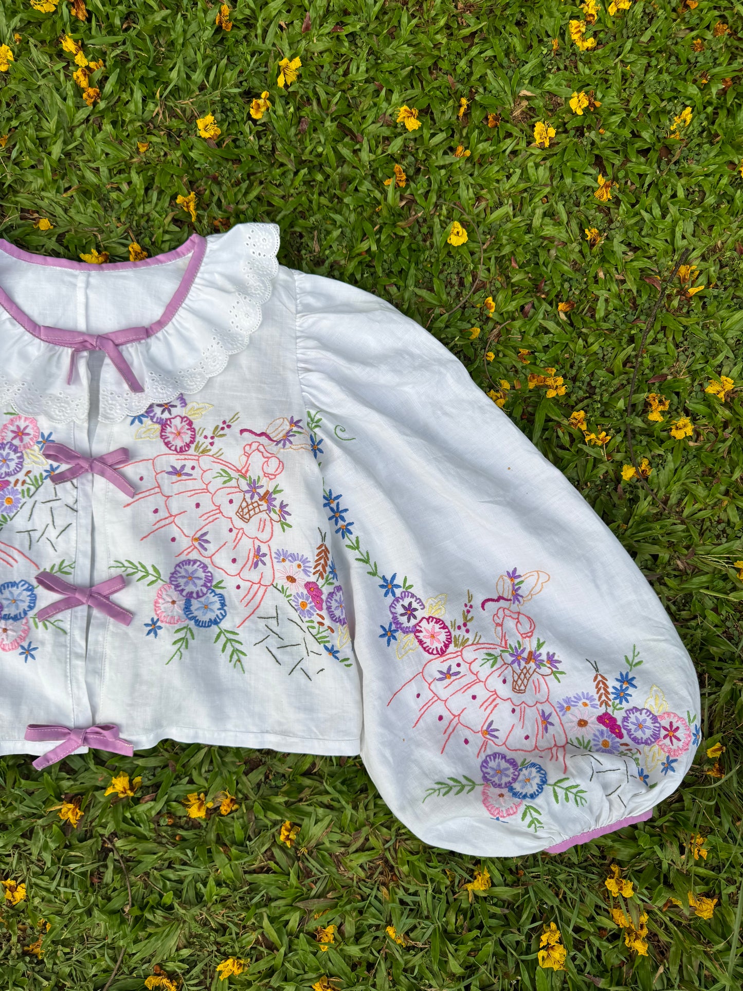 Blouse with lace neckline and lilac trimming