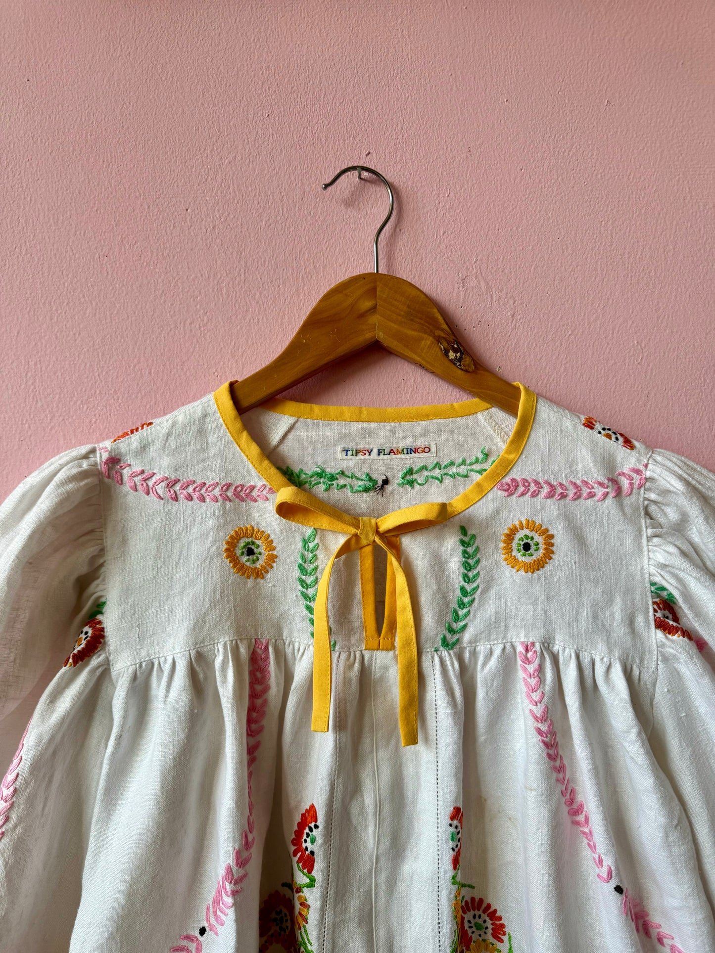 Linen blouse with floral embroidery and yellow binding