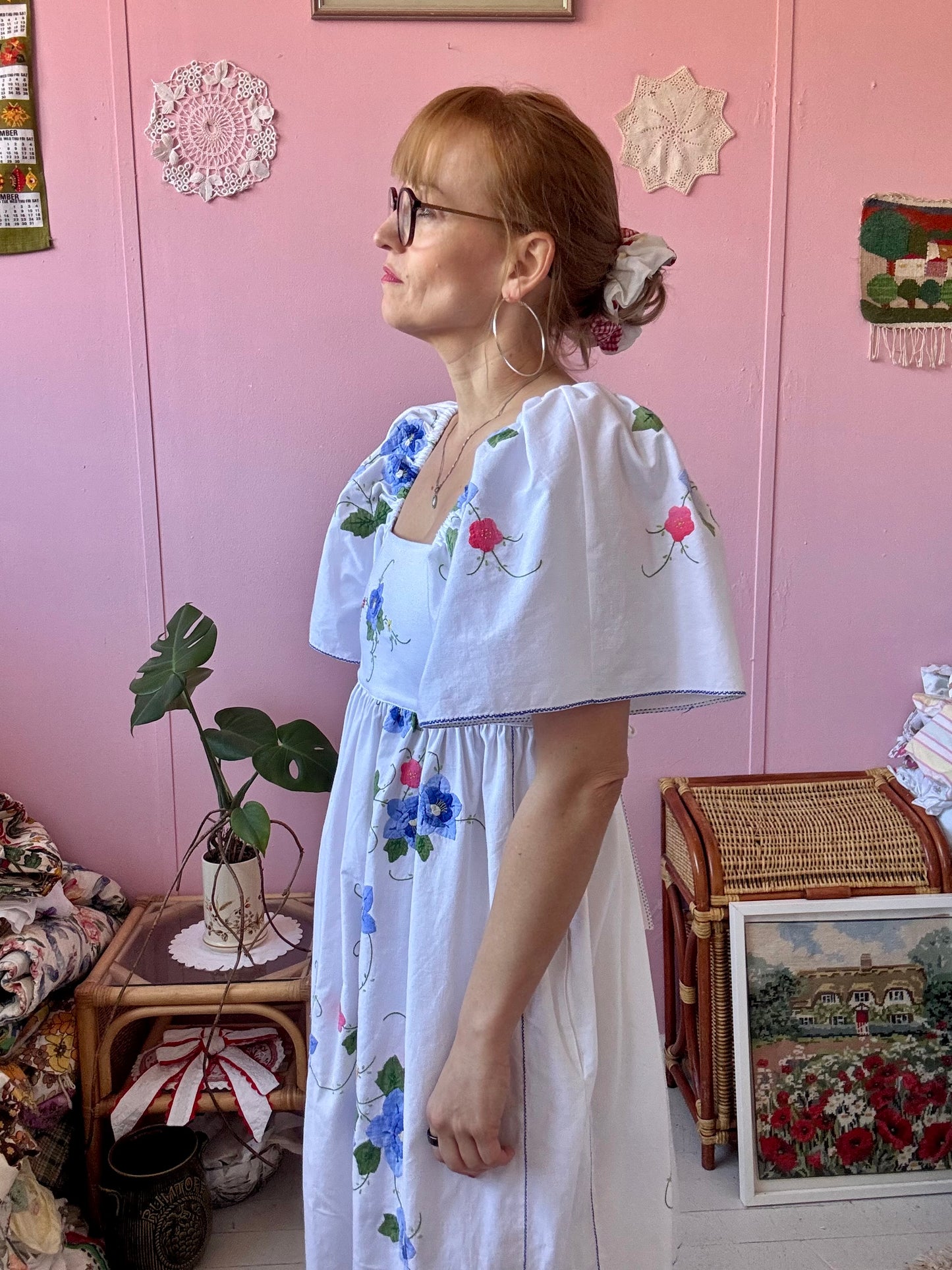 White maxi dress with blue floral appliqués
