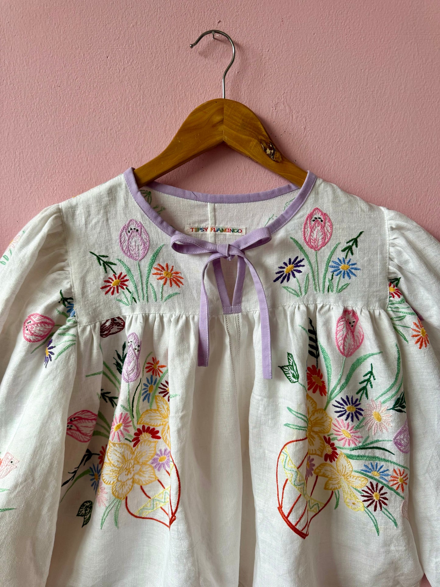 White linen blouse with baskets embroidery and lilac binding