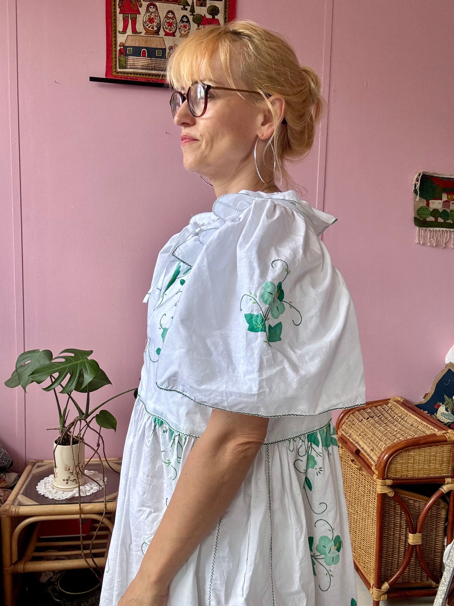 White maxi dress with green floral appliqués