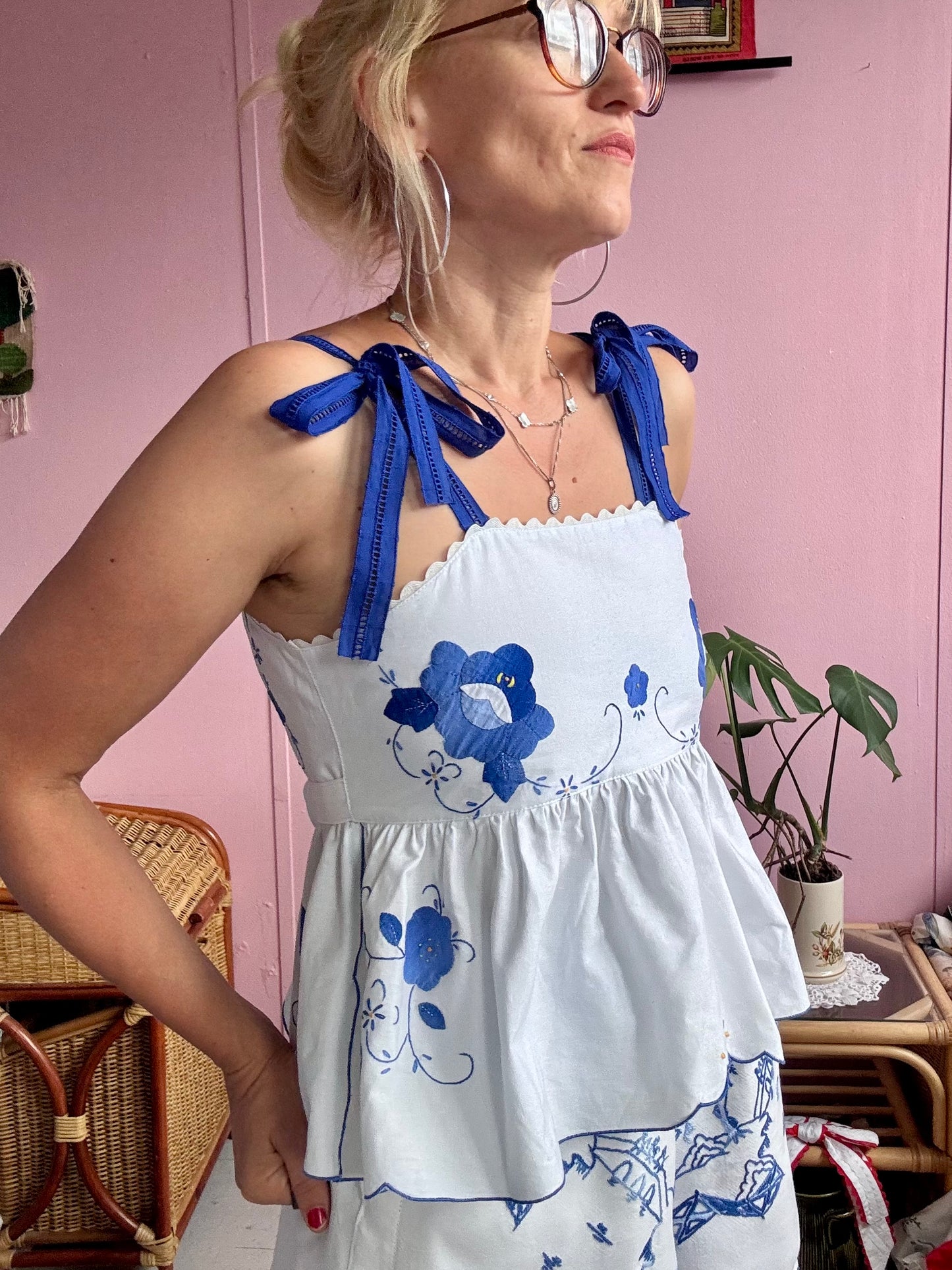 White top with blue floral appliqués