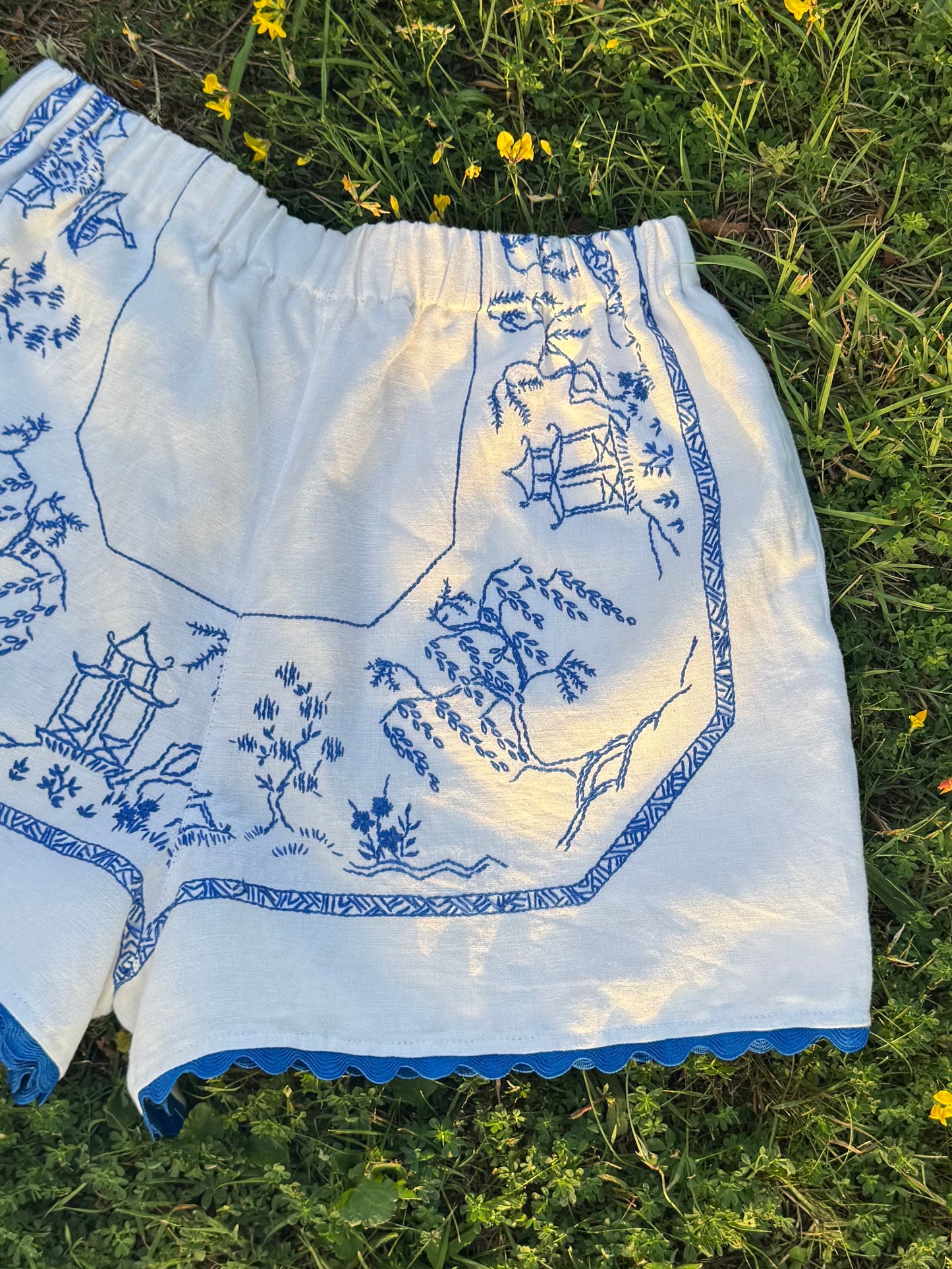 White shorts with blue hand embroidery