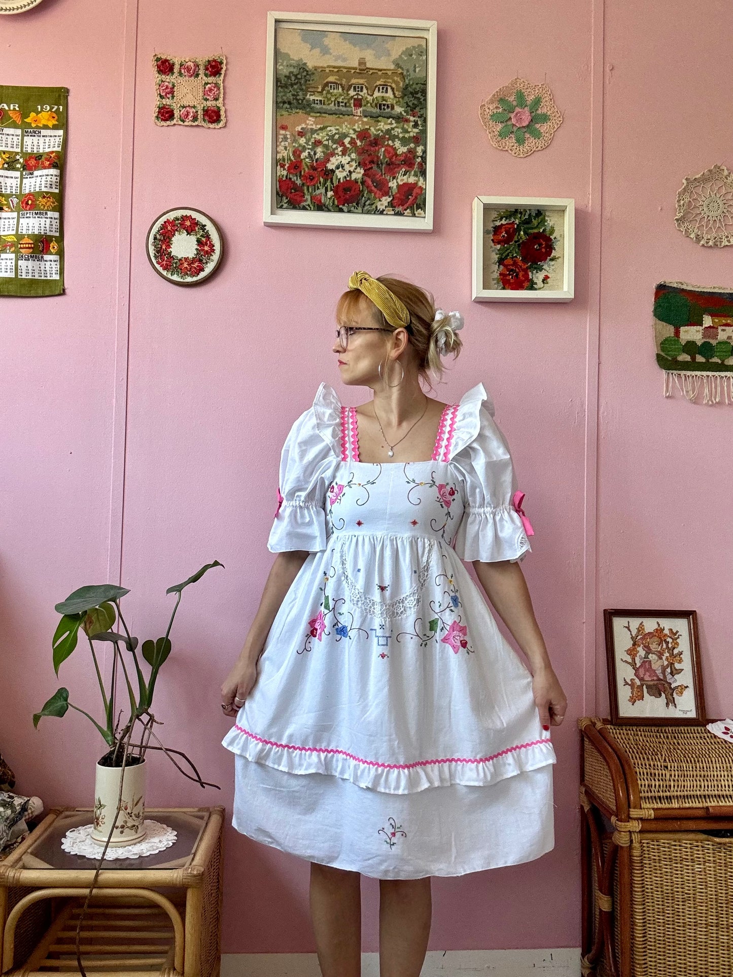 White dress with floral appliqués and pink ric rac