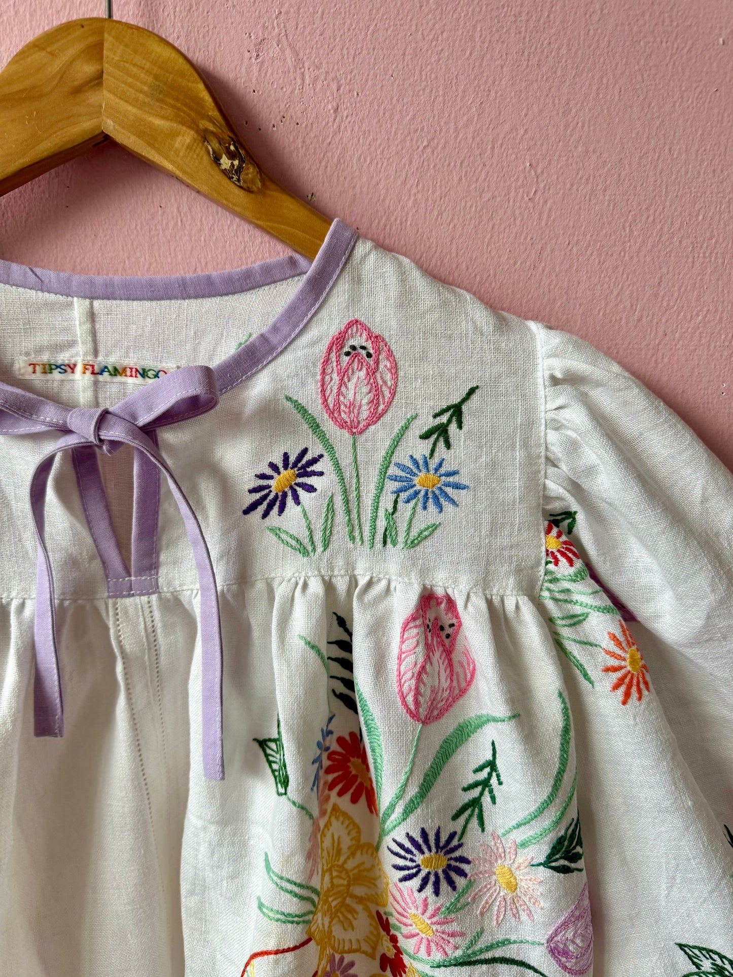 White linen blouse with baskets embroidery and lilac binding