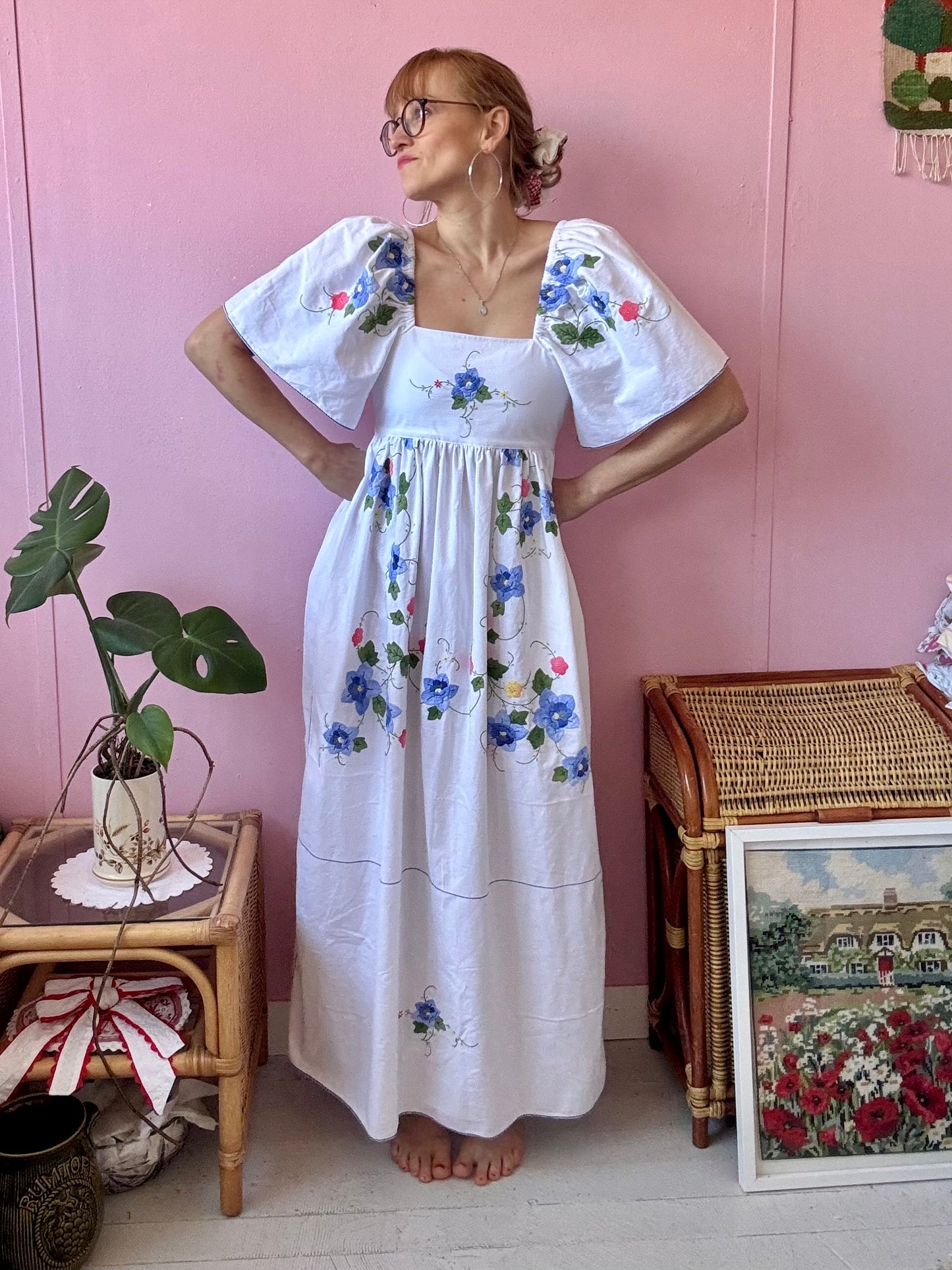 White maxi dress with blue floral appliqués