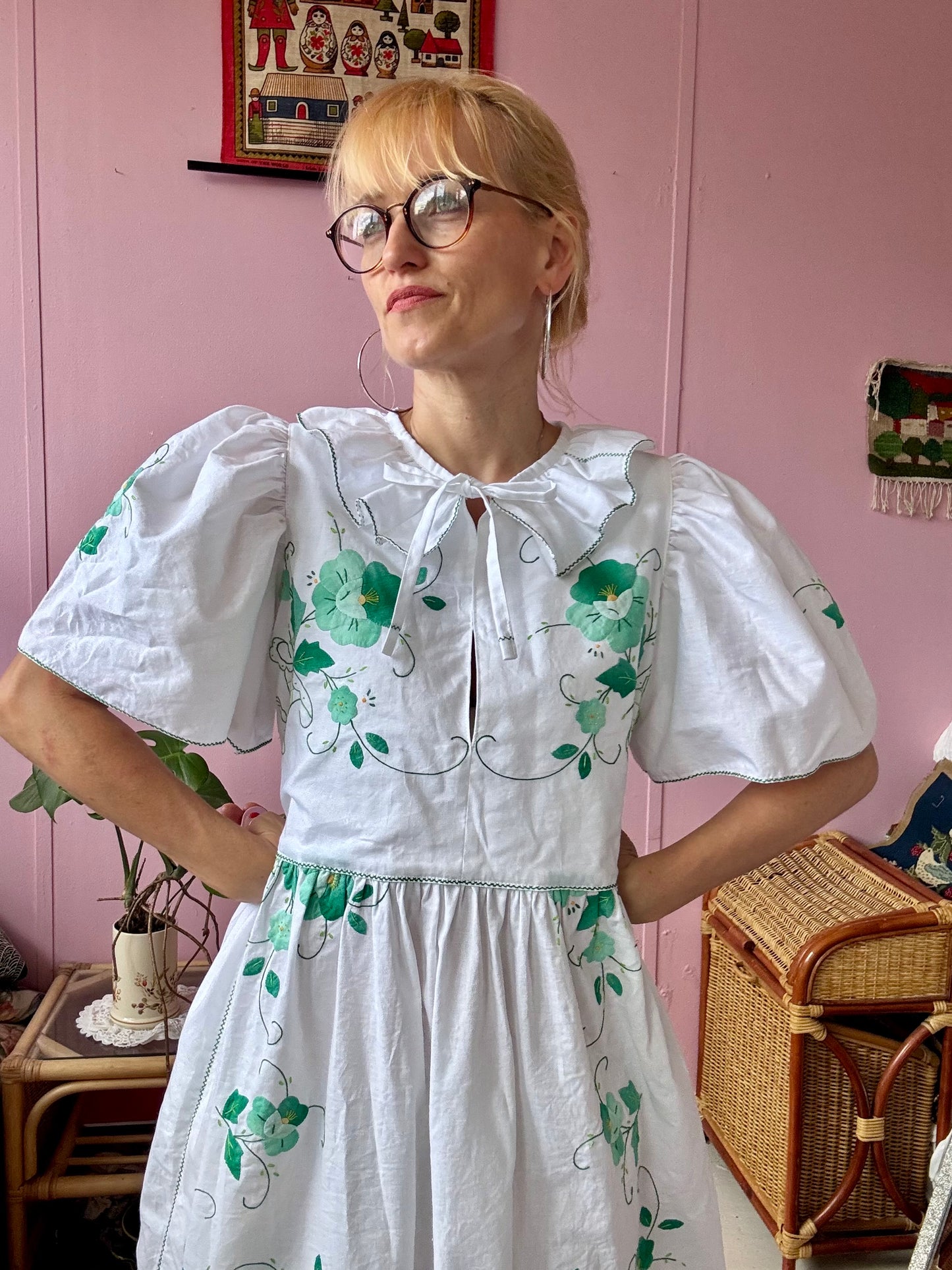 White maxi dress with green floral appliqués