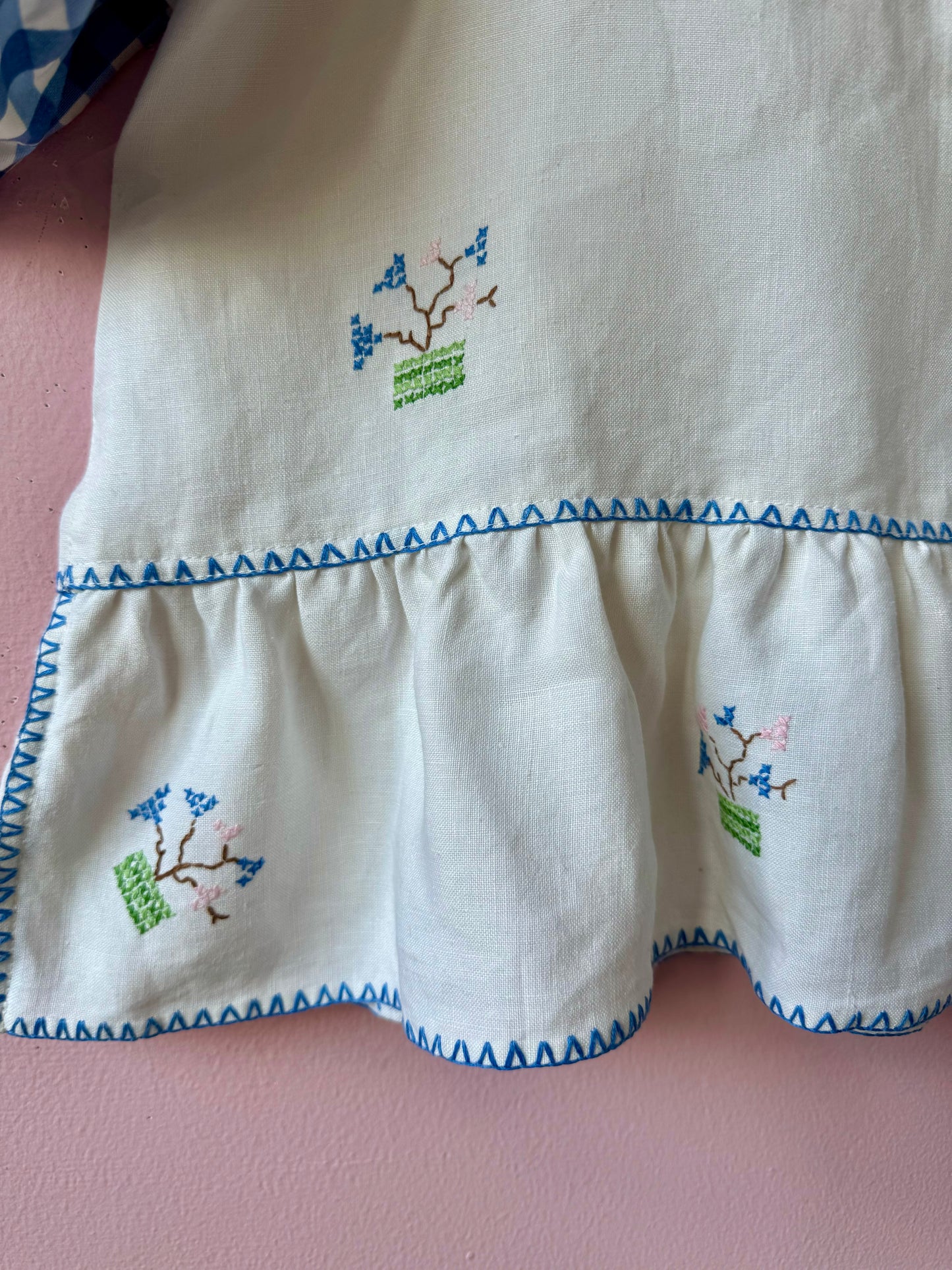 Peplum blouse with hand embroidery and gingham sleeves