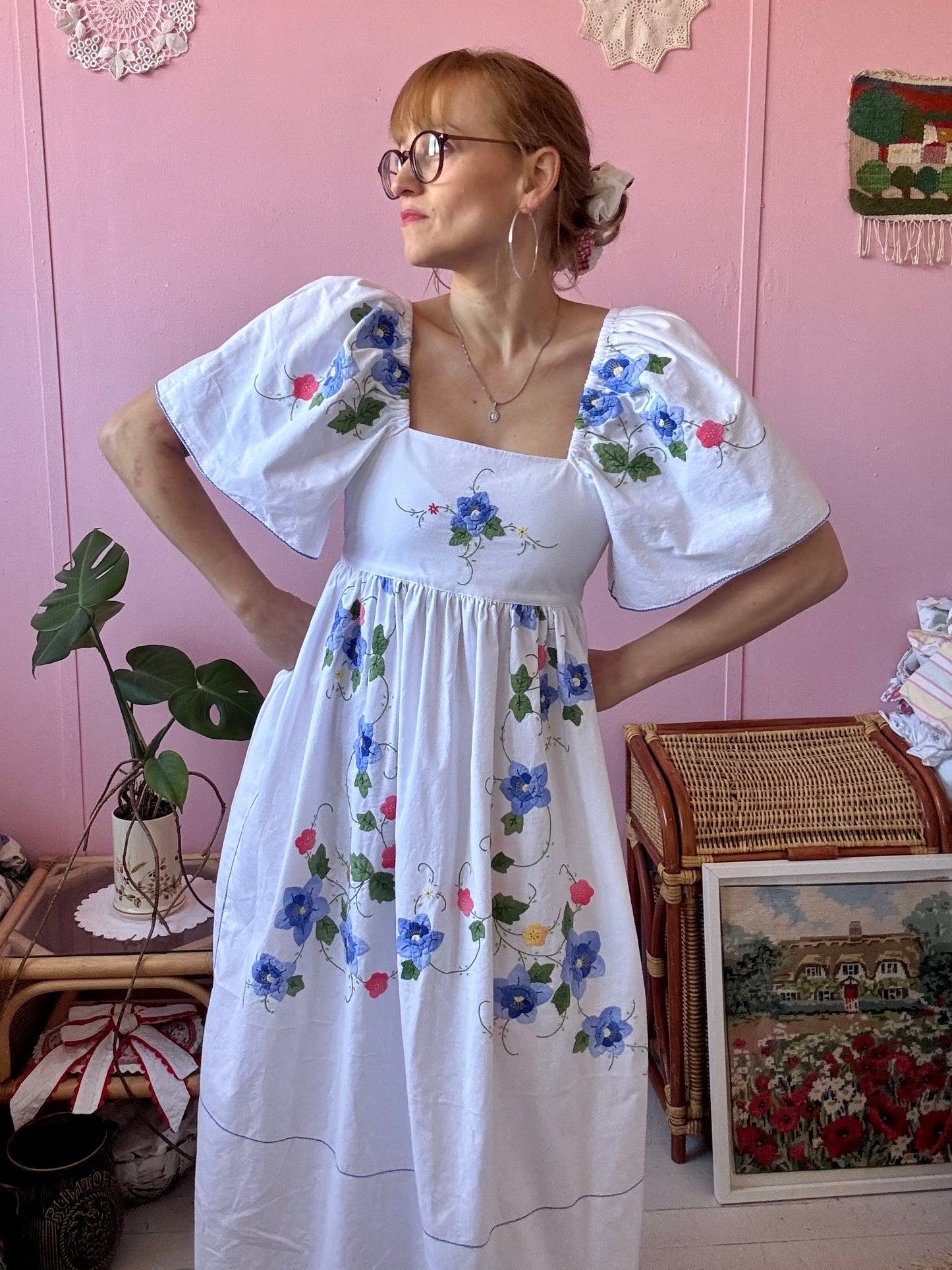 White maxi dress with blue floral appliqués