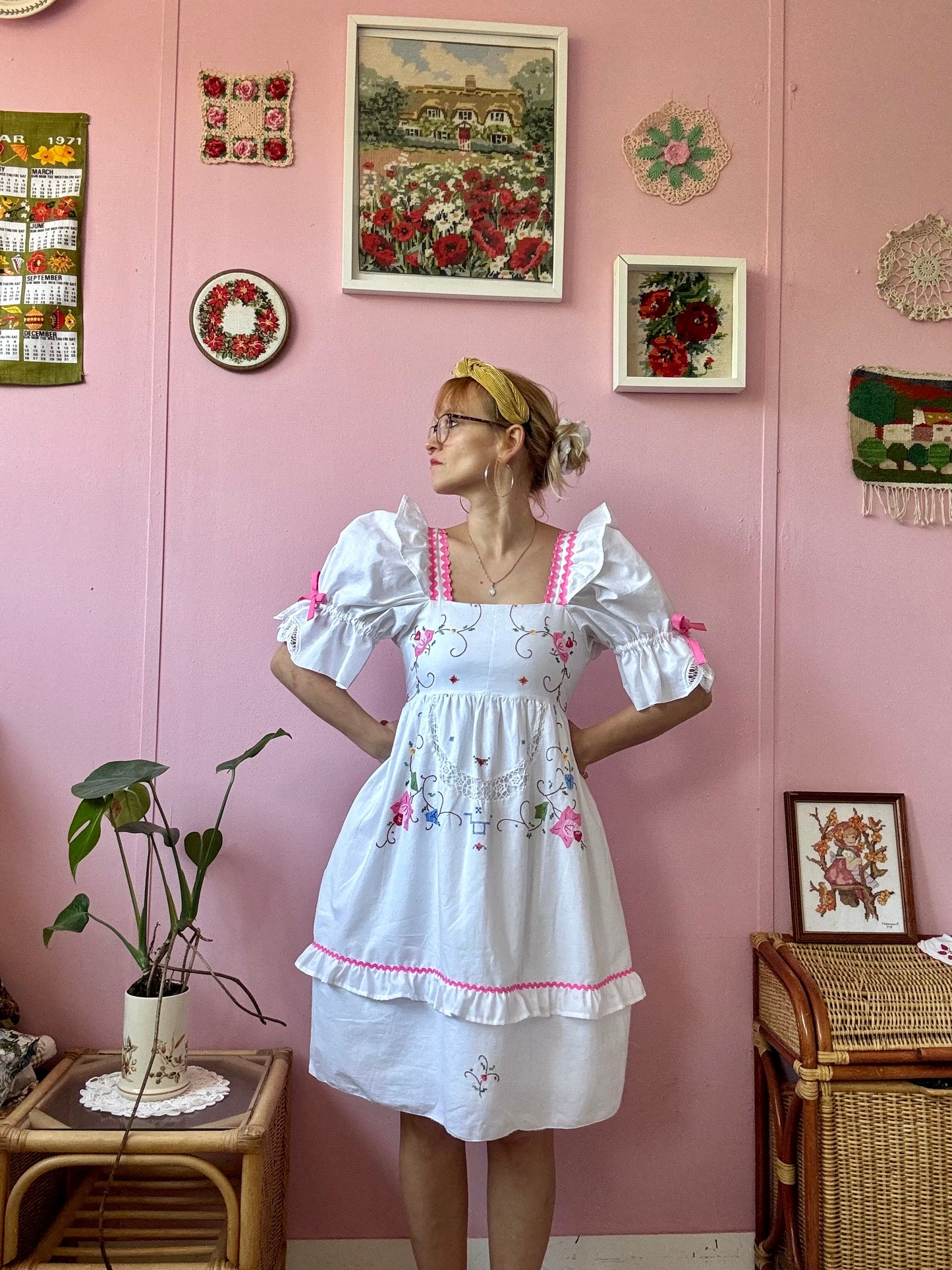 White dress with floral appliqués and pink ric rac