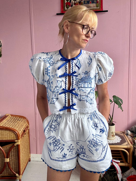 White shorts with blue hand embroidery