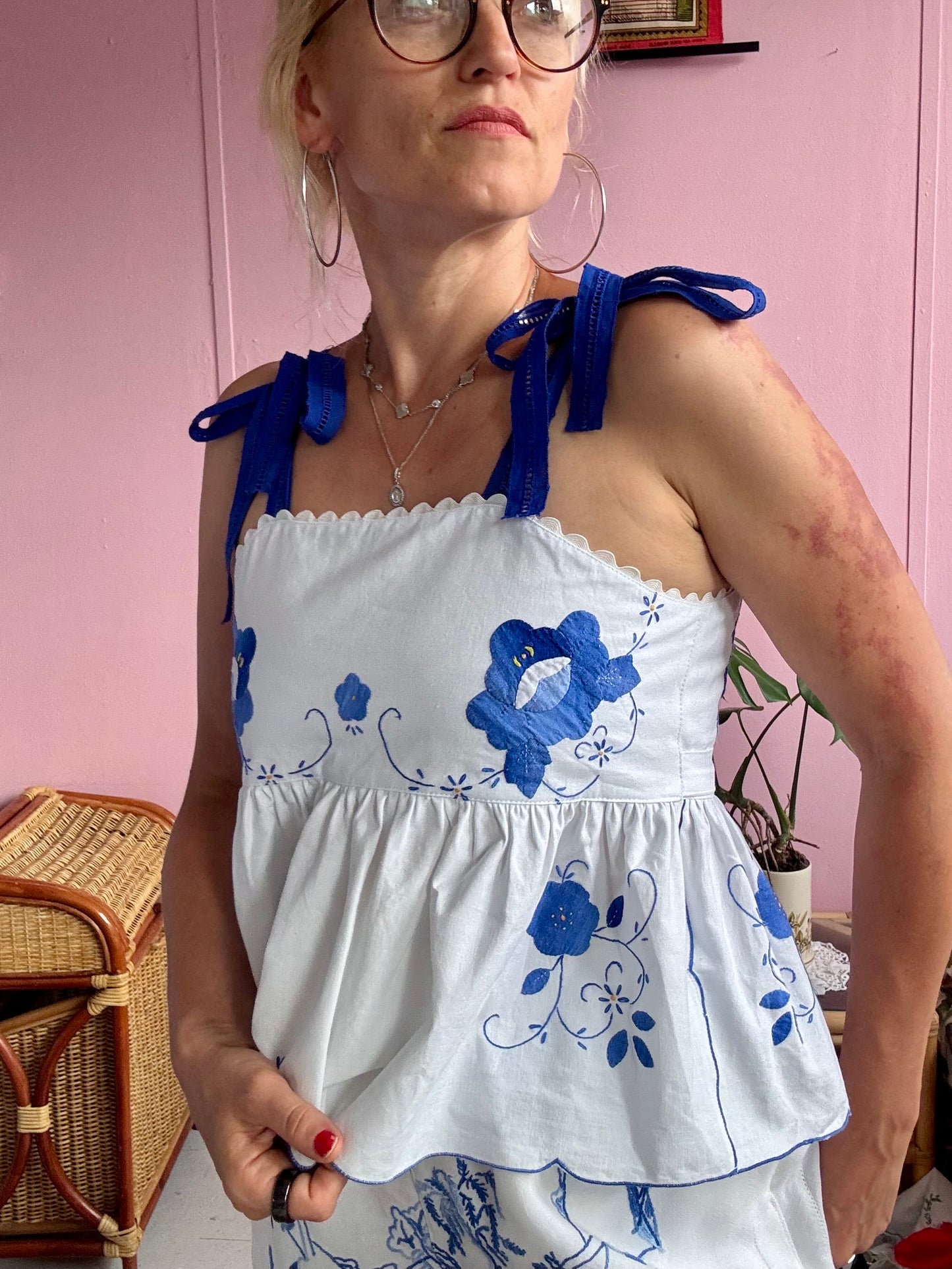 White top with blue floral appliqués