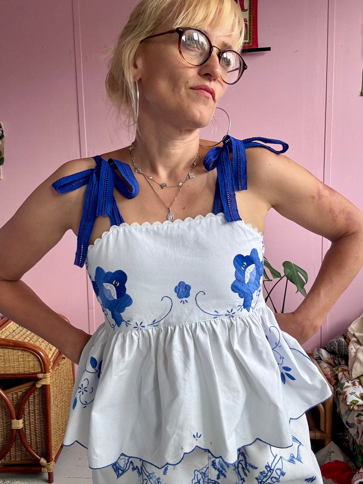 White top with blue floral appliqués