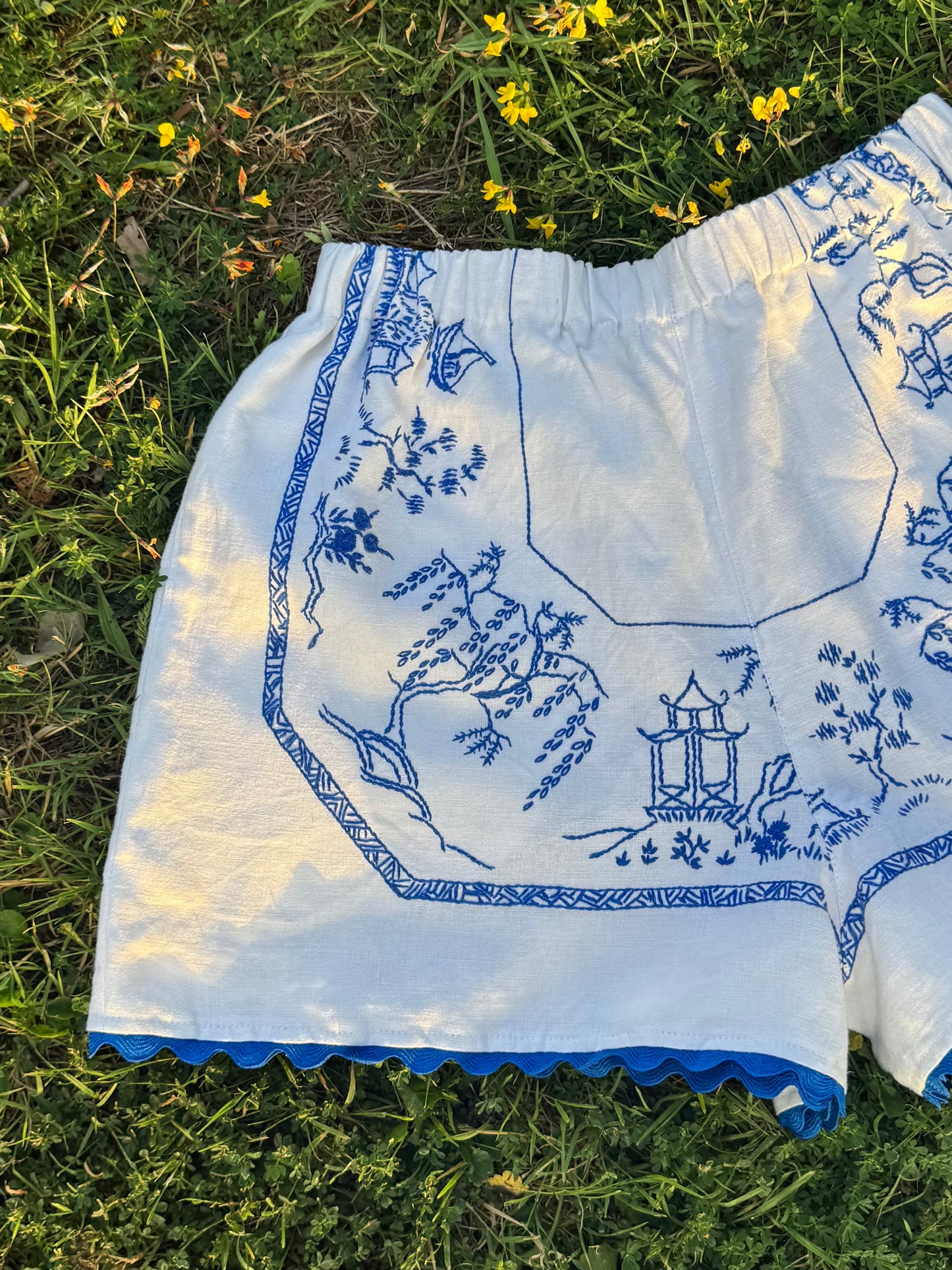White shorts with blue hand embroidery