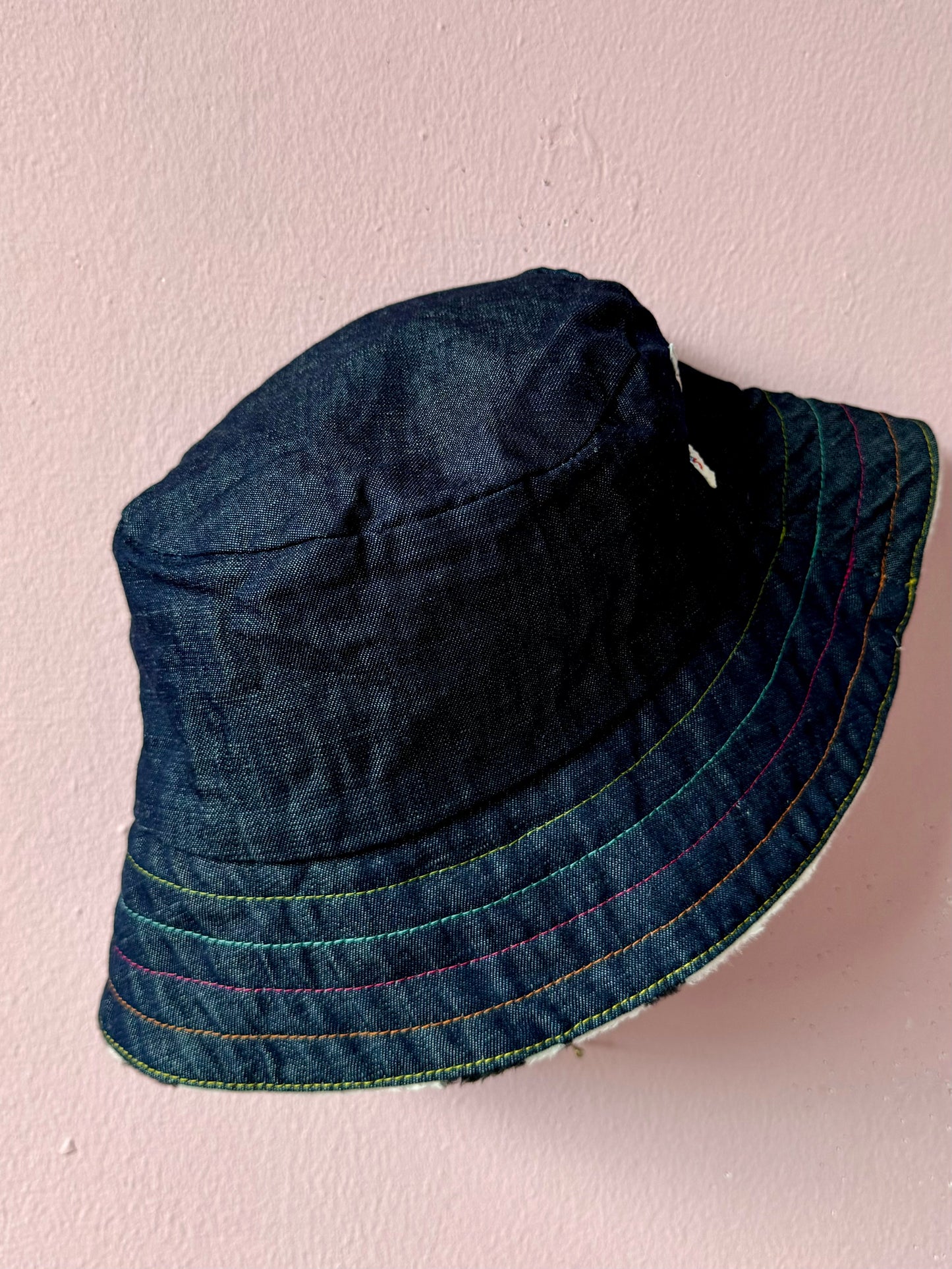 Reversible faux cow fur and denim with rainbow stitching bucket hat