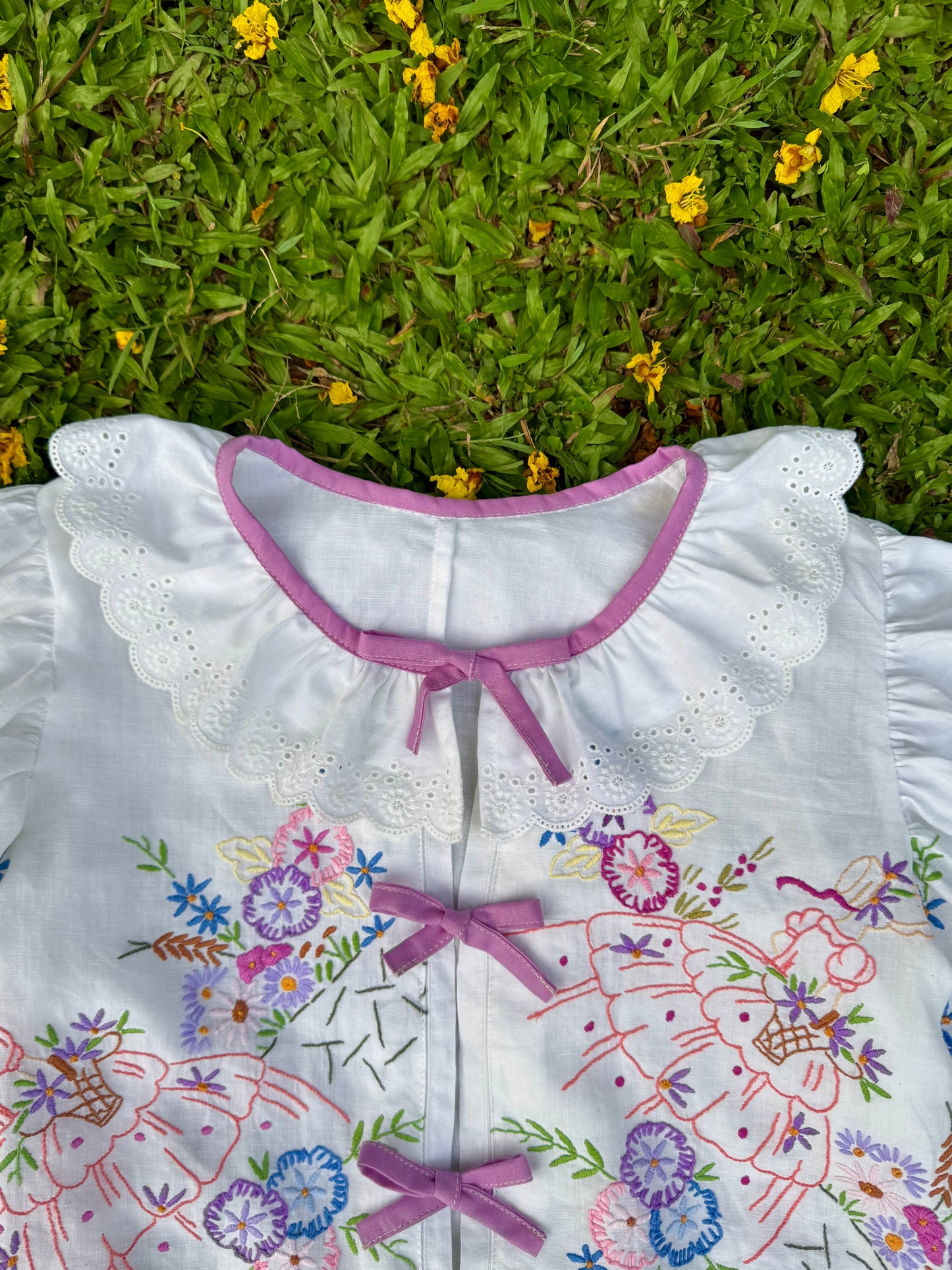 Blouse with lace neckline and lilac trimming