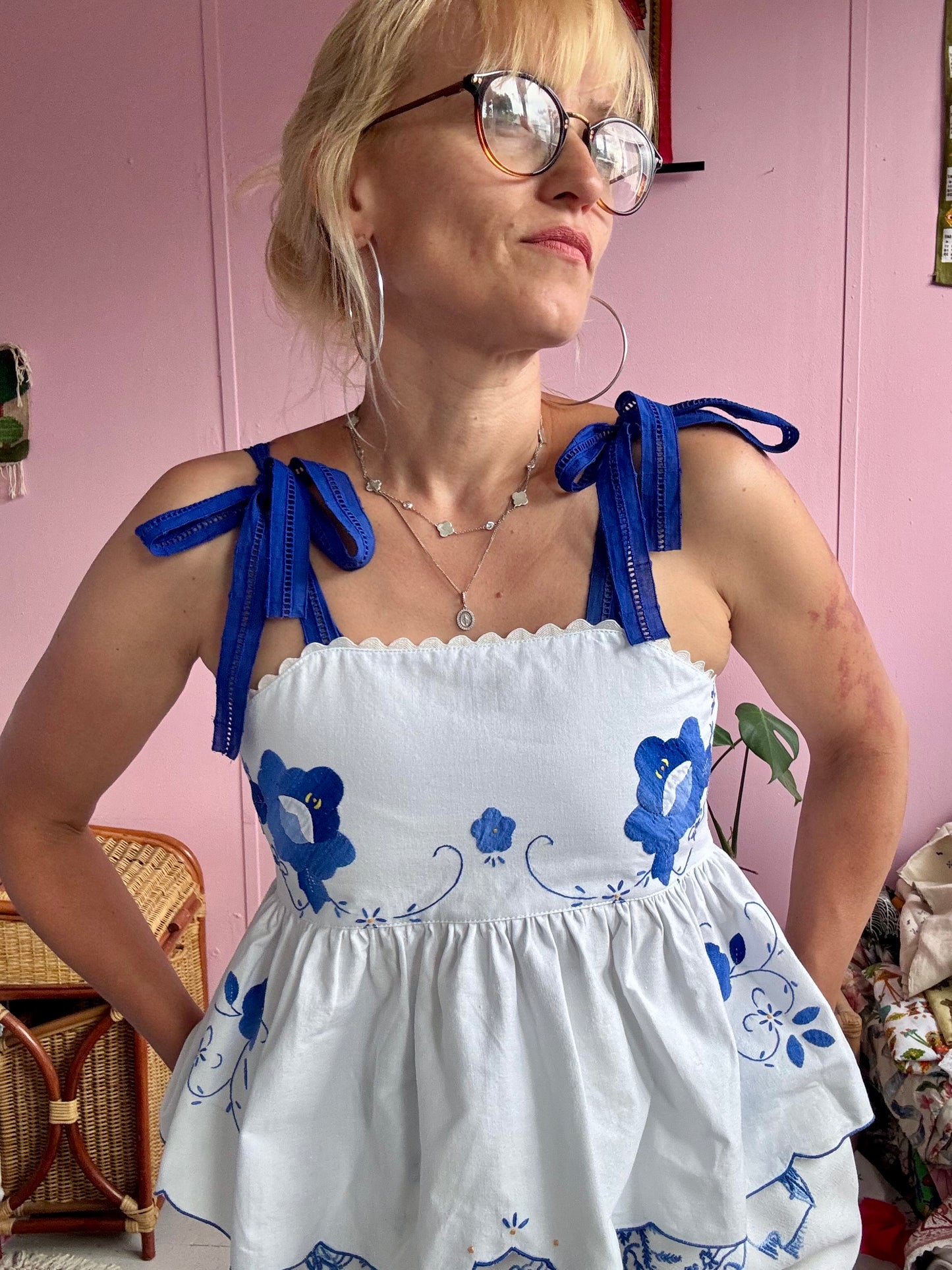White top with blue floral appliqués