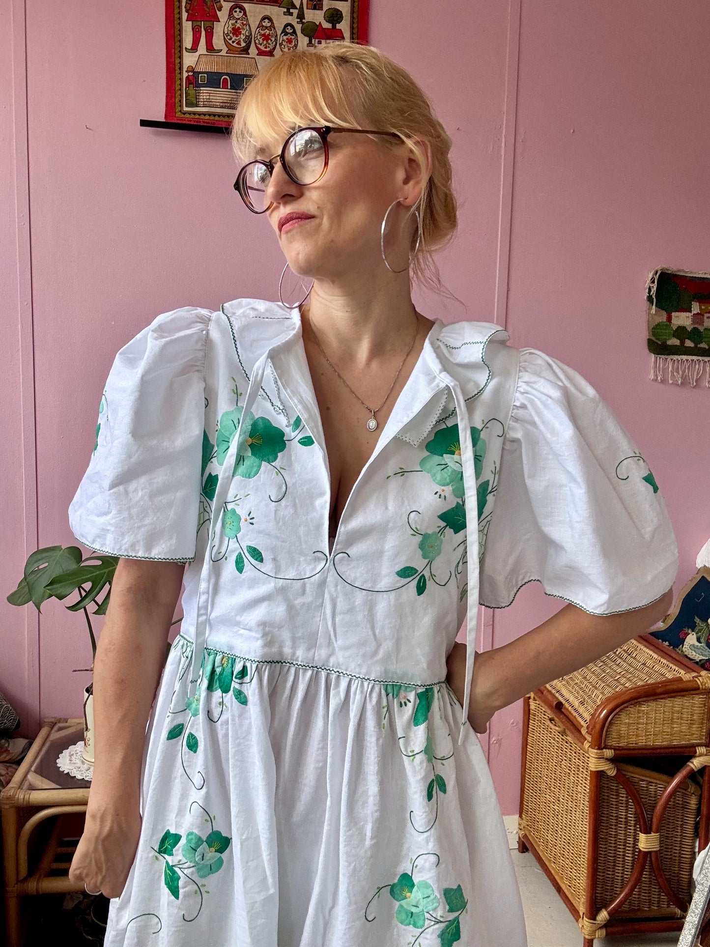 White maxi dress with green floral appliqués