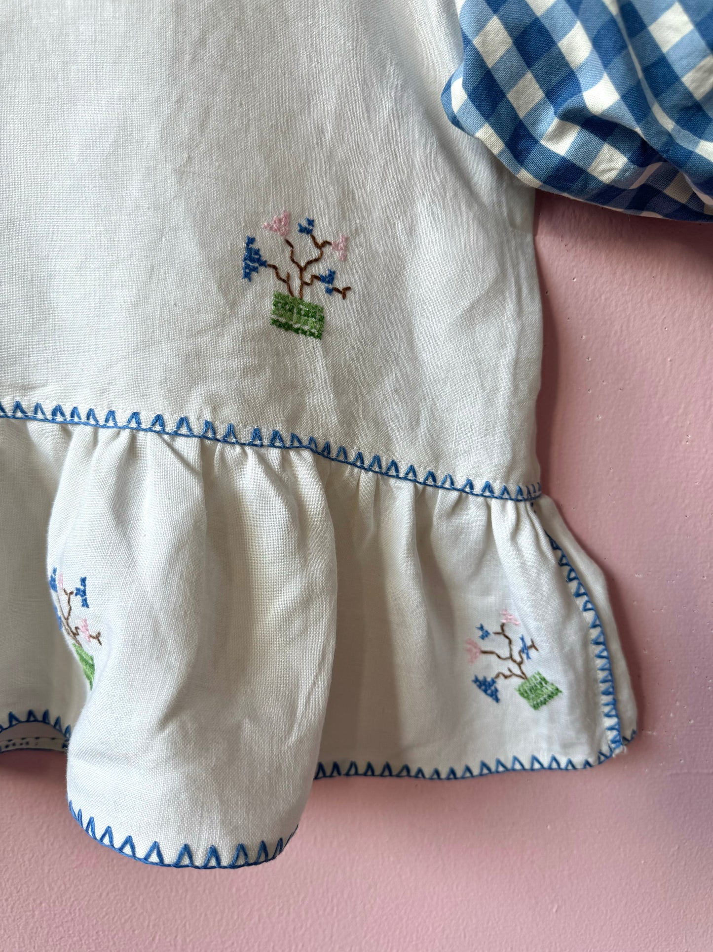 Peplum blouse with hand embroidery and gingham sleeves