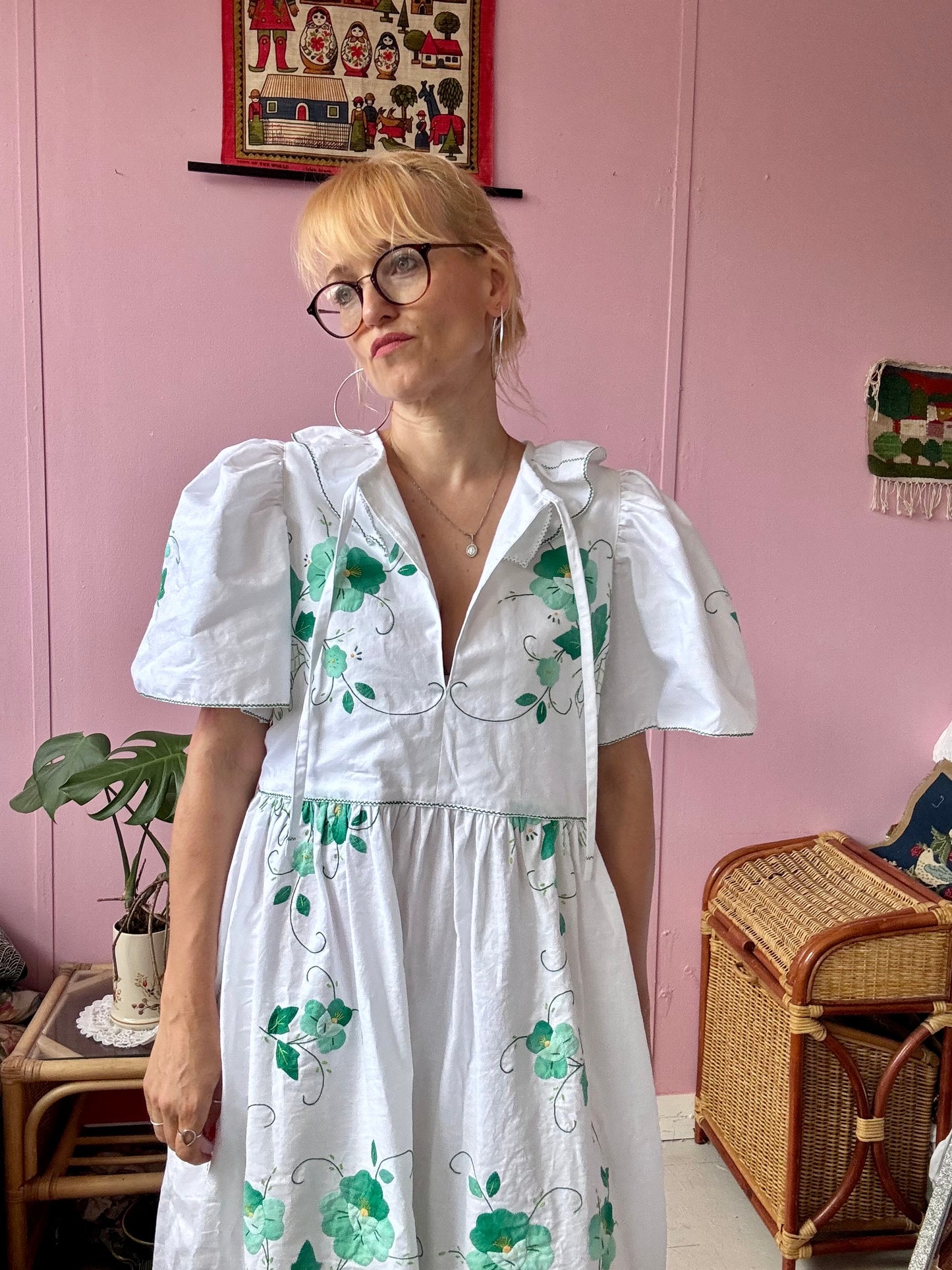 White maxi dress with green floral appliqués