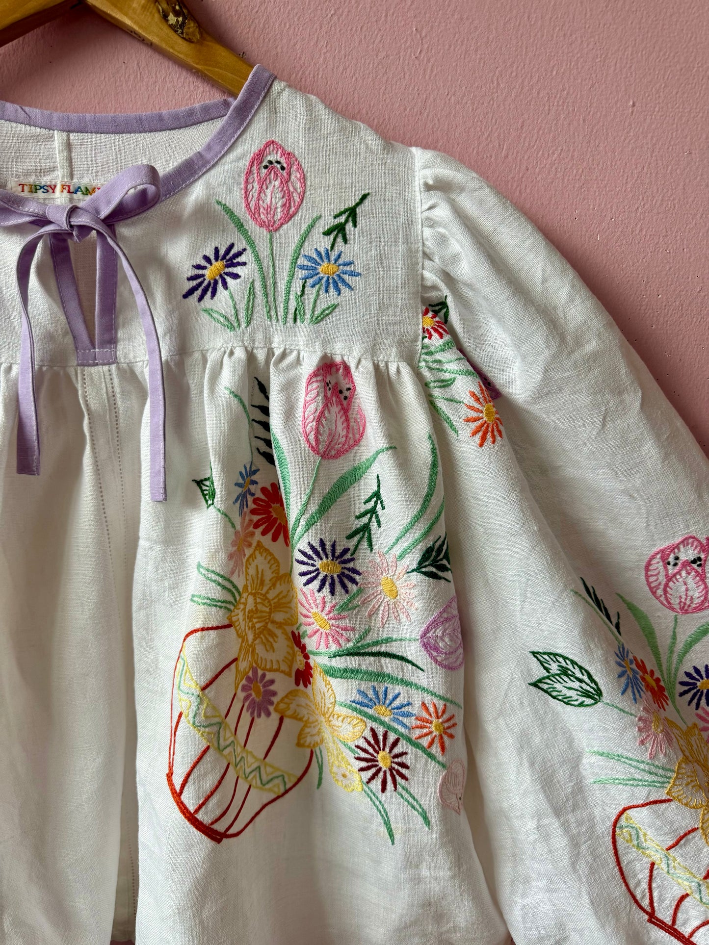 White linen blouse with baskets embroidery and lilac binding
