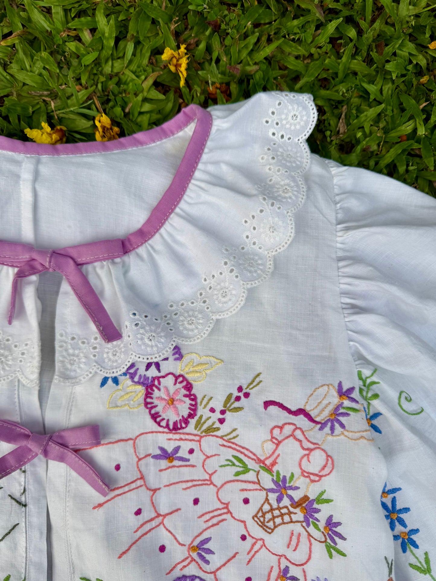 Blouse with lace neckline and lilac trimming