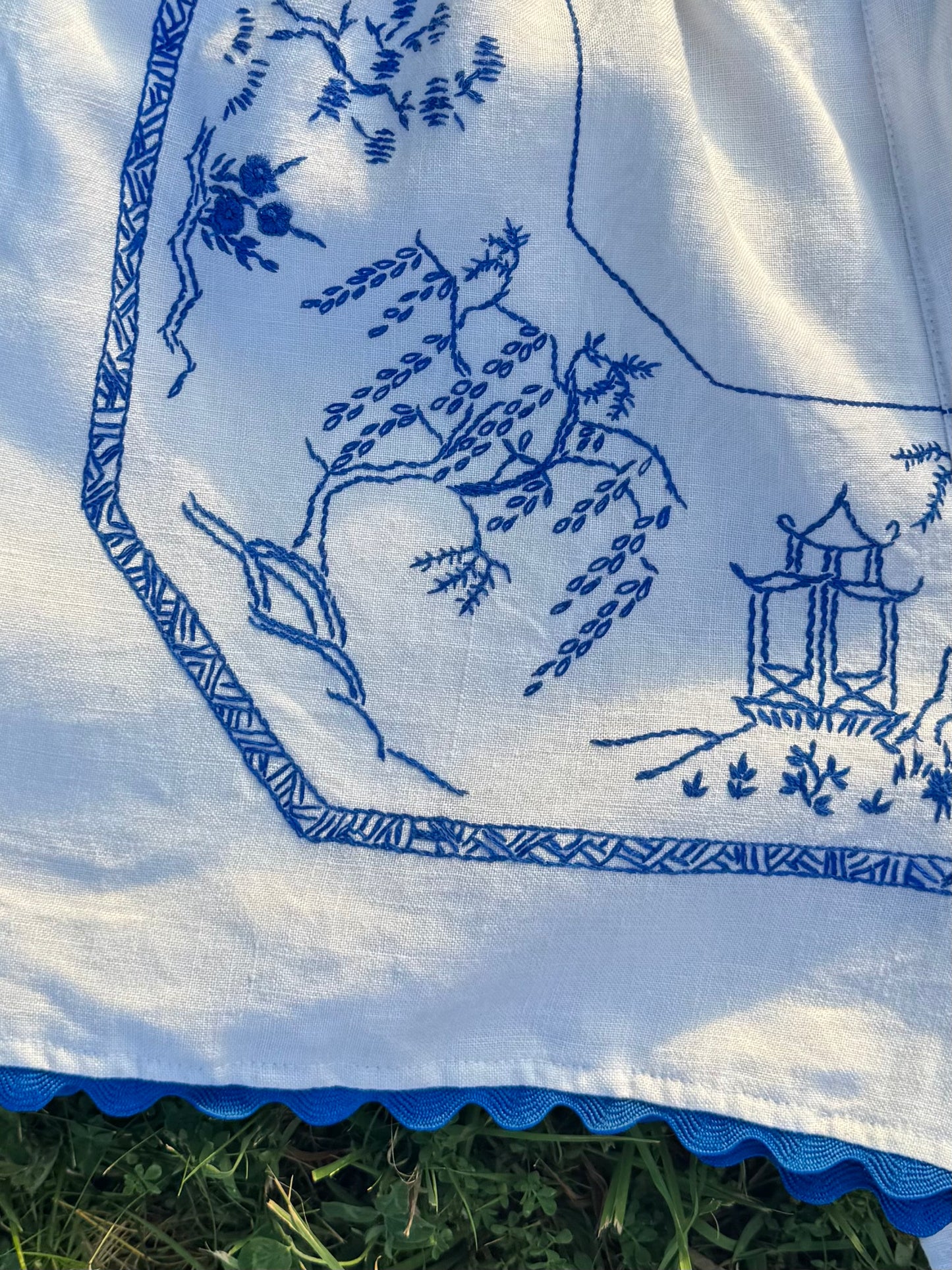 White shorts with blue hand embroidery