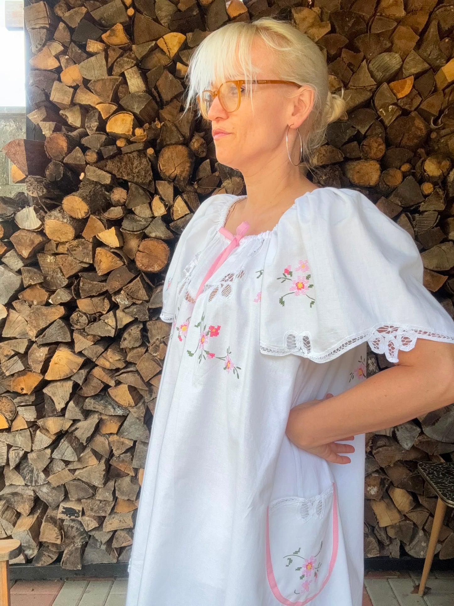 White dress with pink bow and pink cross stitching flowers