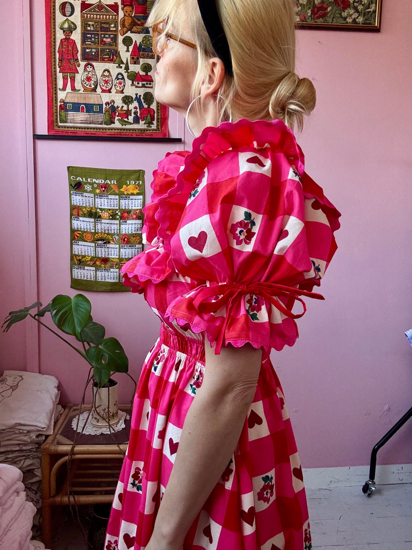 Pink/red dress with frills and ric rac