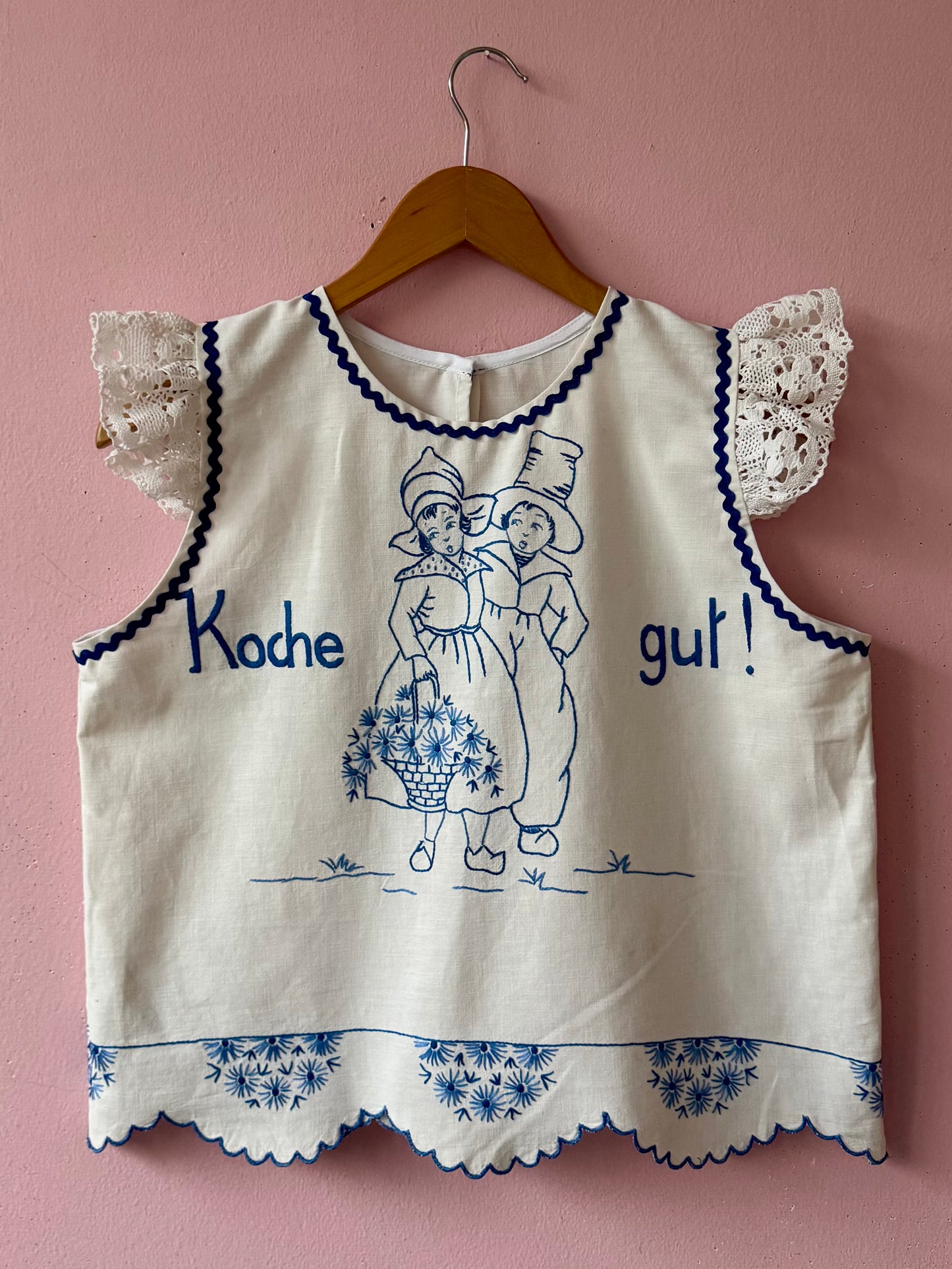 White top with blue hand embroidery