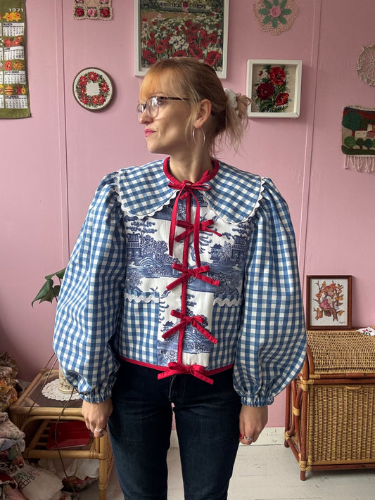 Blue and white jacket with red bows